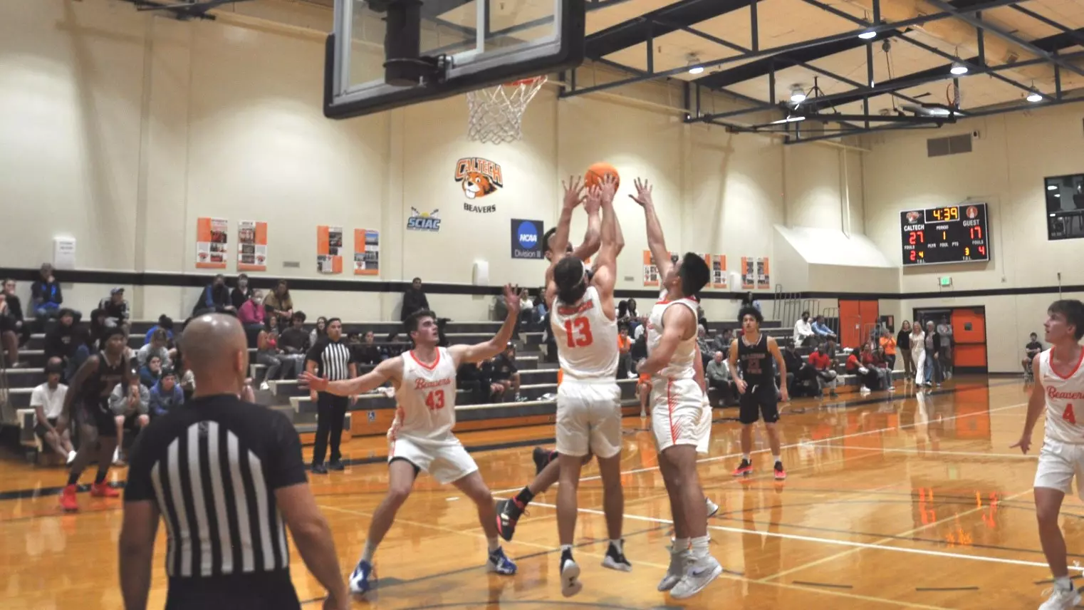 Caltech Men's Basketball players battle for a rebound against Illinois Tech