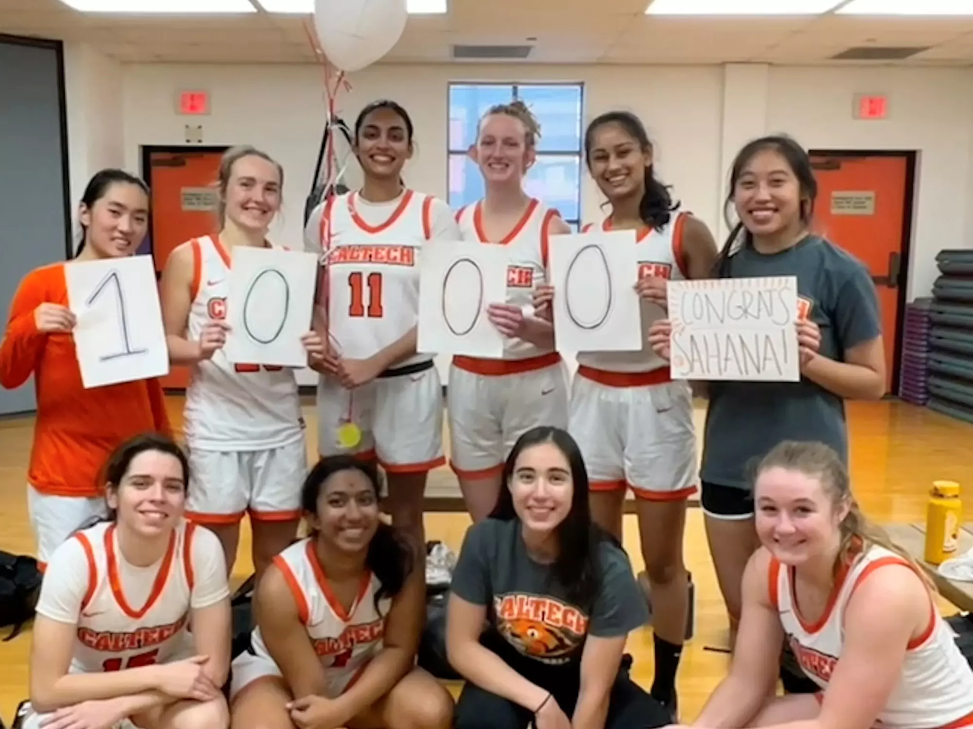 Women's Basketball players celebrate with Sahana Saikumar after she crossed the 1000 career points mark