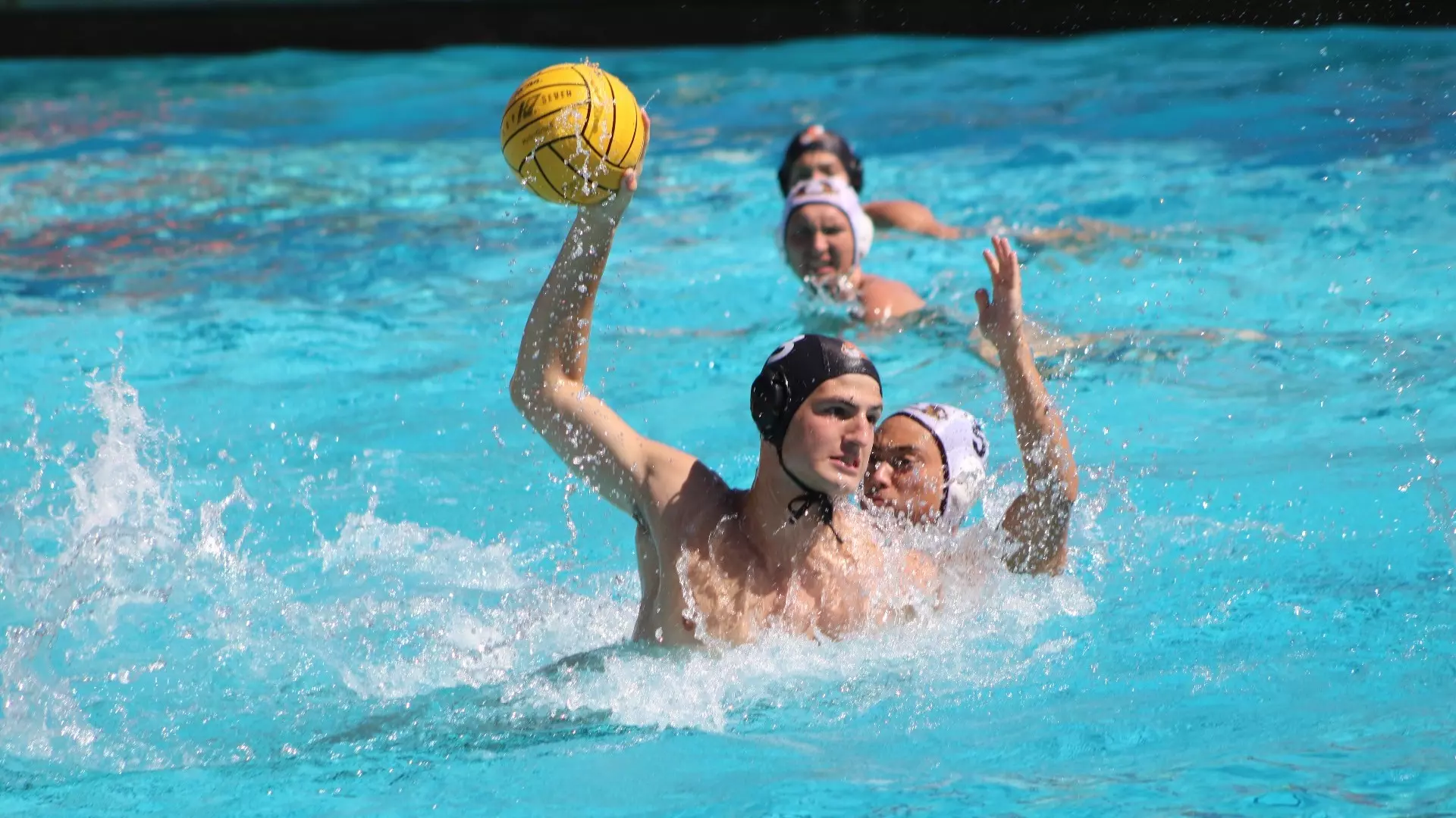 Bram Shork holds the ball up high while a CMS player guards him