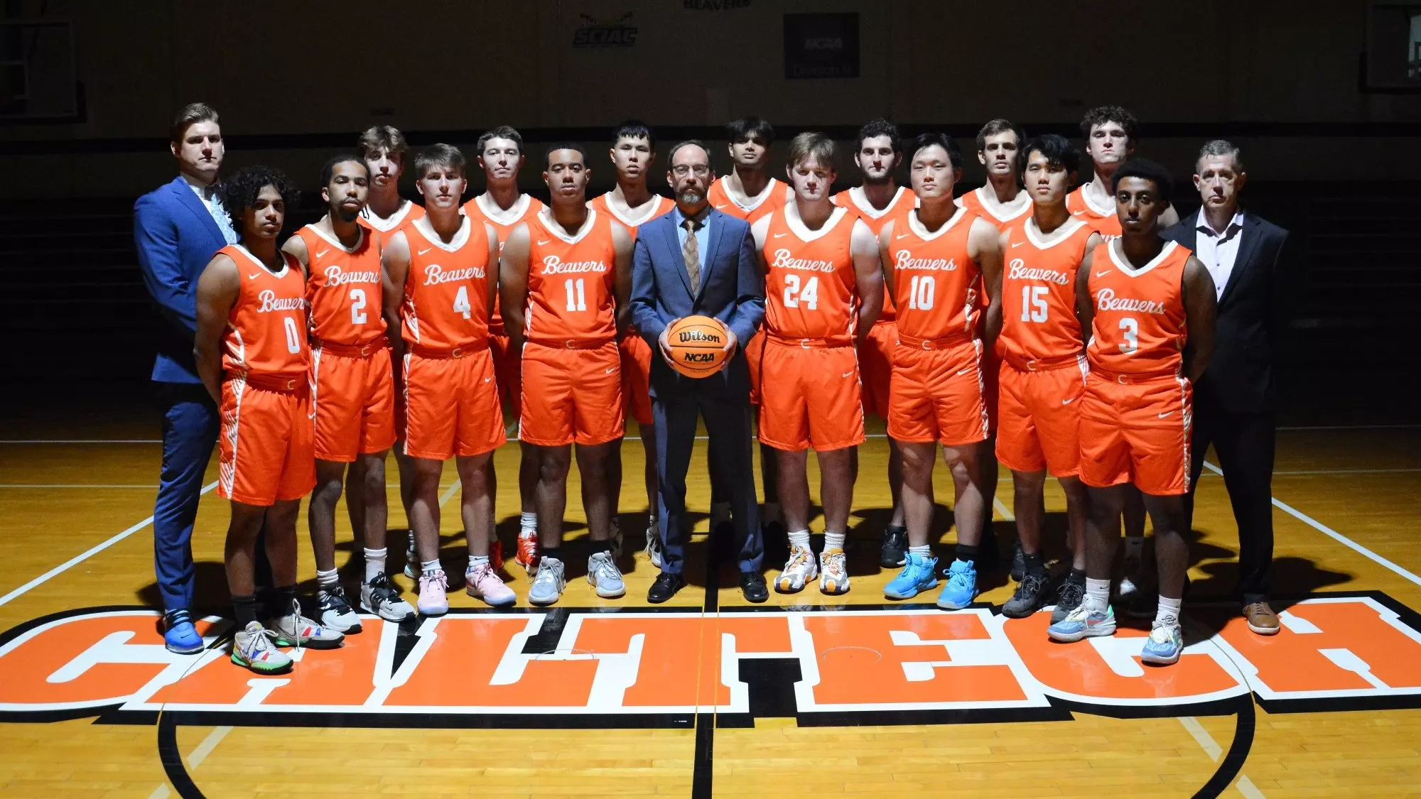 Caltech Men's Basketball team poses at center court