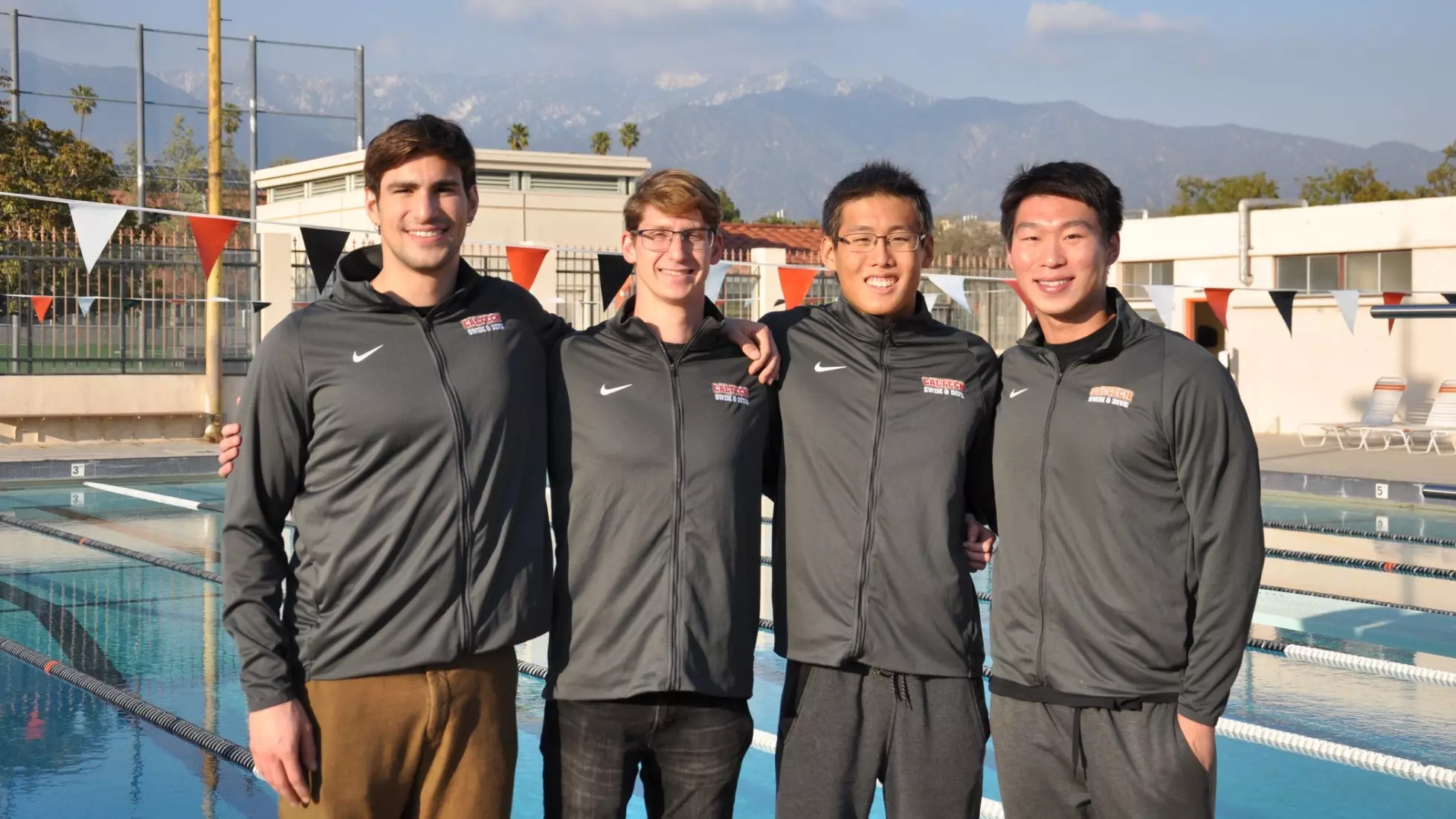 Naci Keskin, Christopher Pukszta, Leo Yang and Simon Hu pose in front of the Alumni Pool