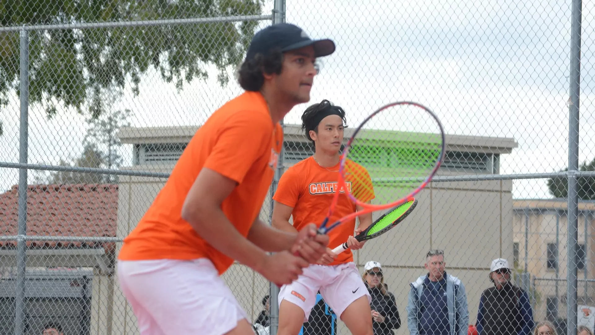 Rishi Gundakaram and Nathan Zuo defend their side of the court in a doubles tennis match