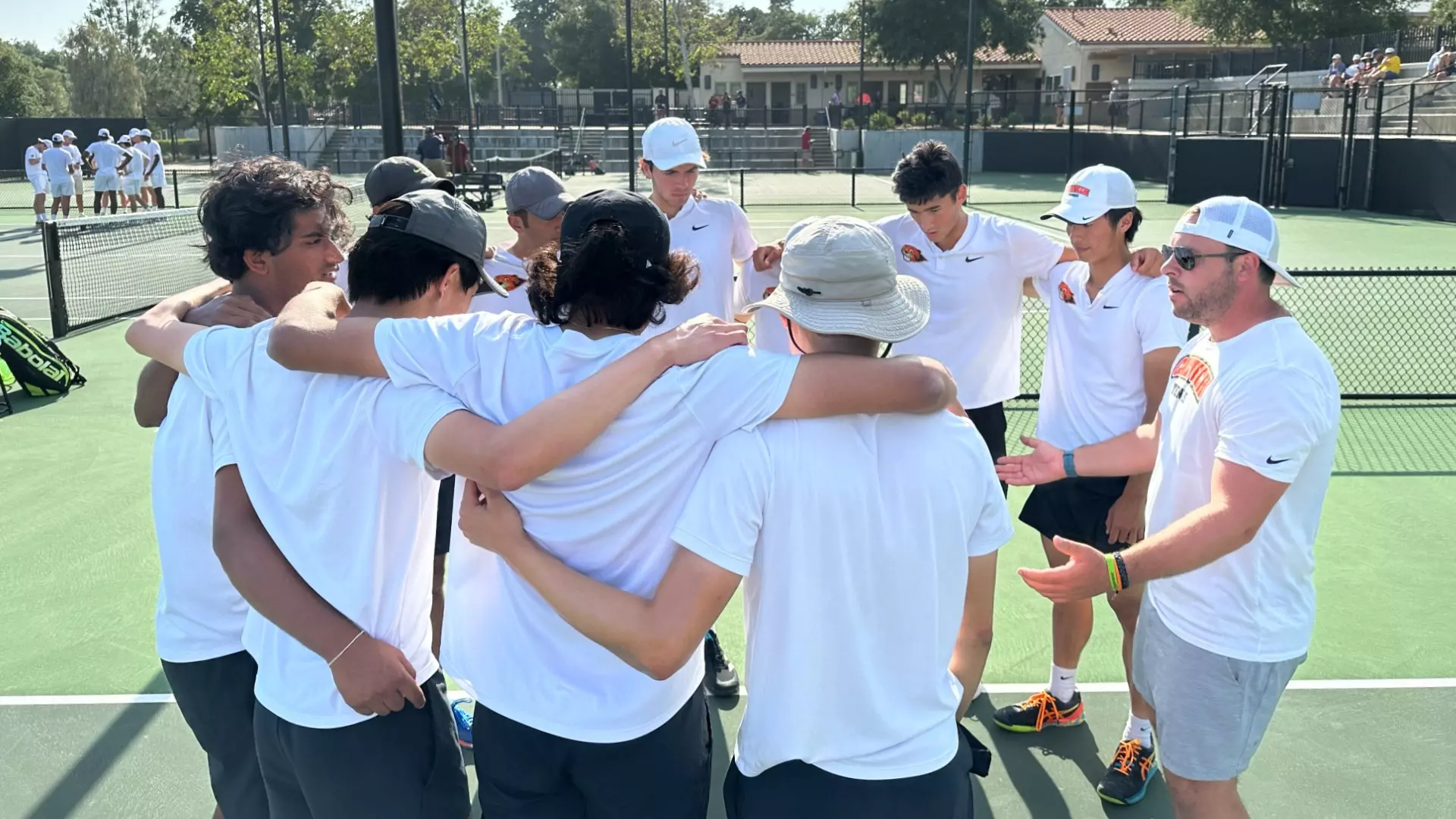 Men's Tennis team huddles before the singles session at the 2023 SCIAC Championship