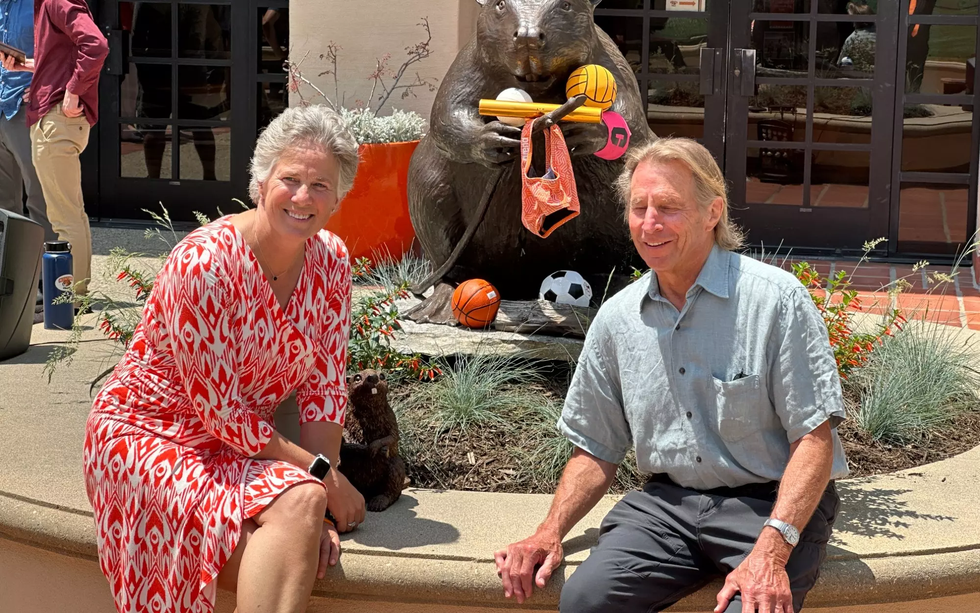 Betsy Mitchell with the new beaver statue and its sculptor