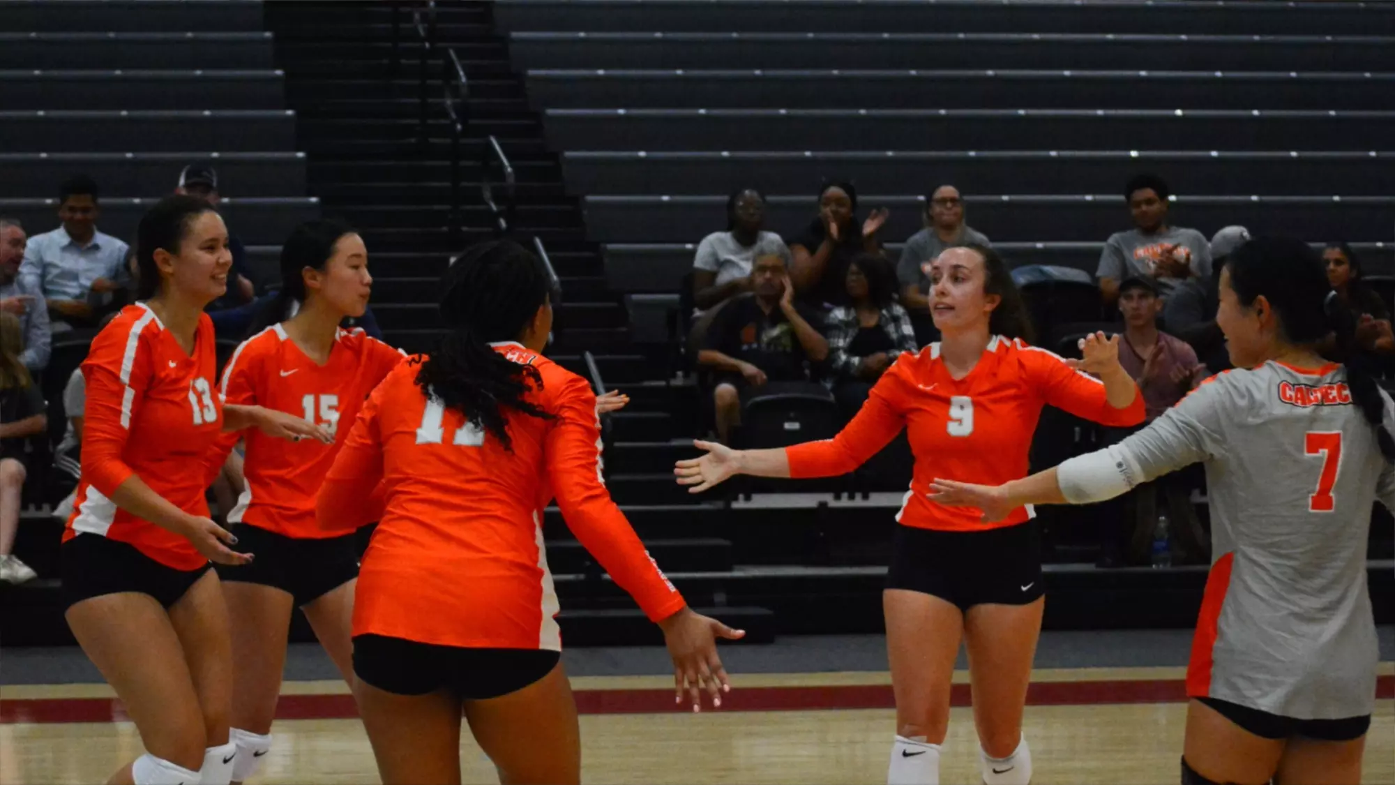 Caltech Volleyball players celebrate after scoring a point at West Coast Baptist College