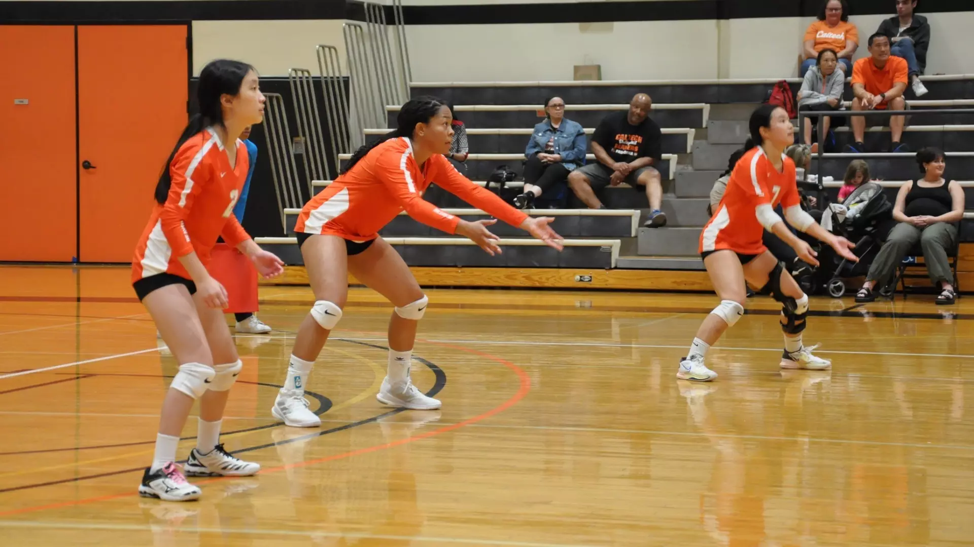 Caltech volleyball players await the serve