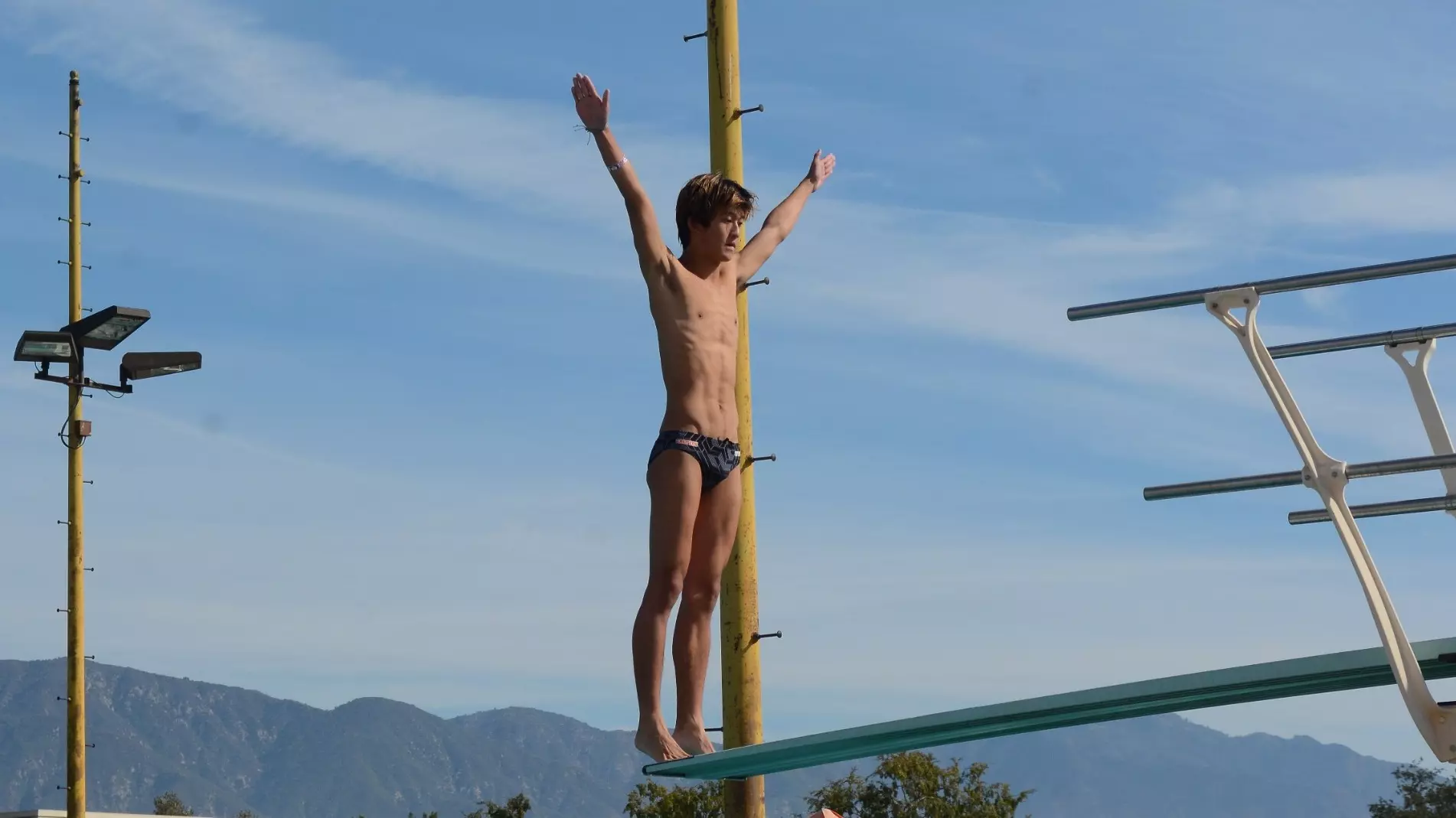 Anthony Wang on diving board preparing to dive 