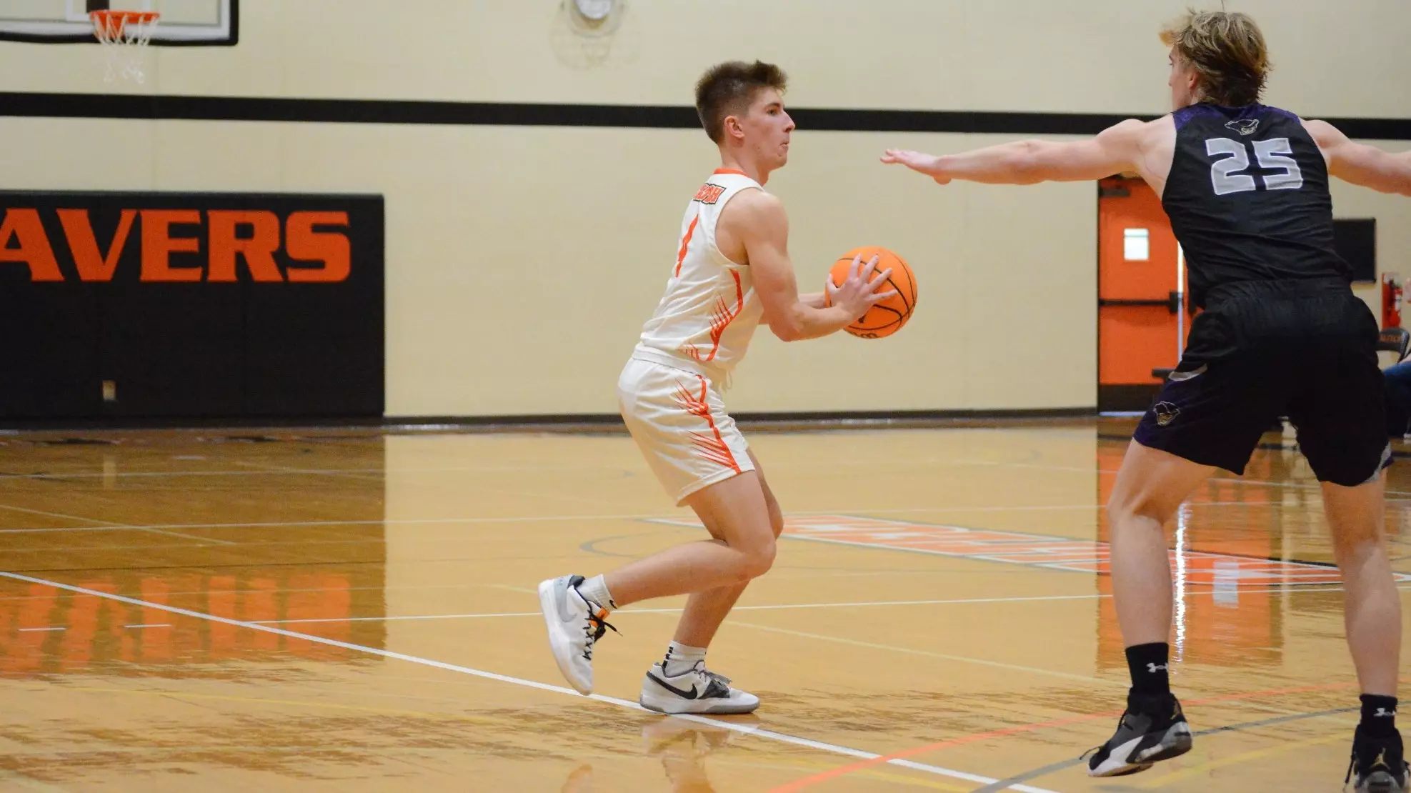 Noah Hicks with ball taking on defender 