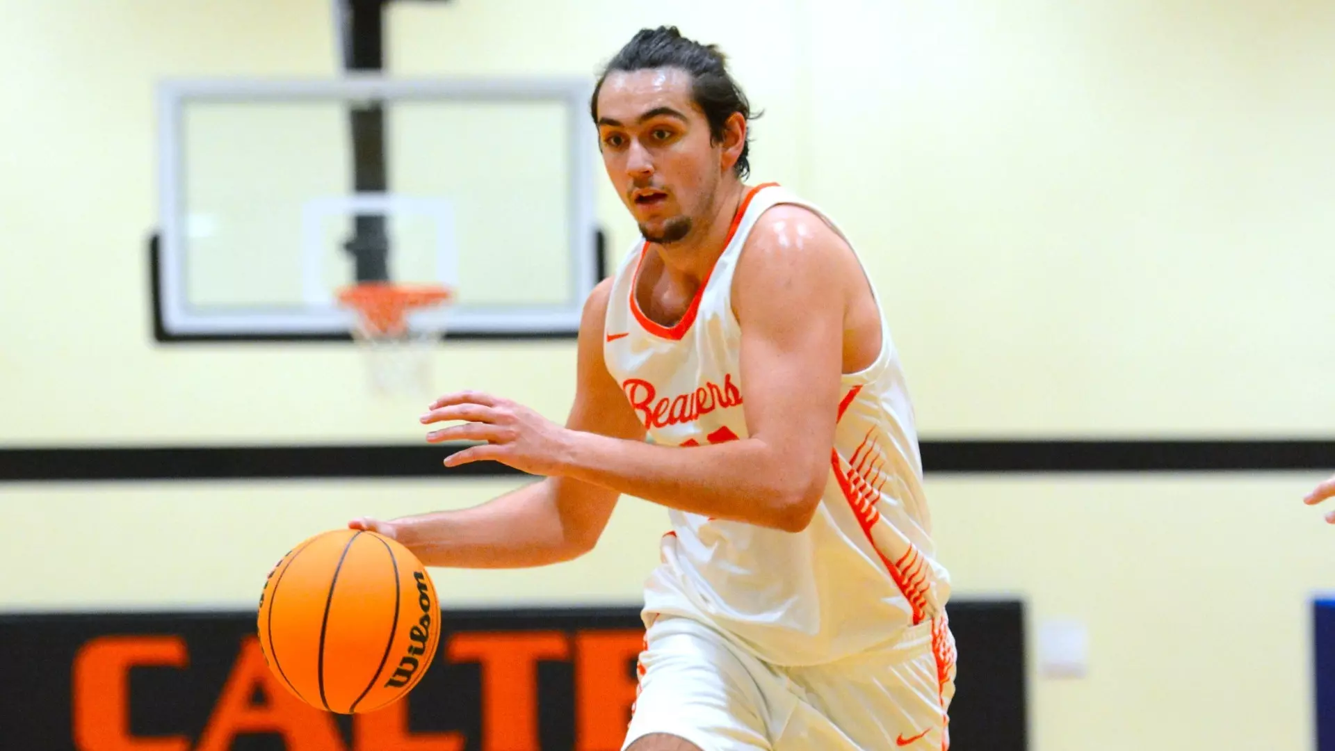 Photo of Caltech Men's Basketball's Stuart Florescu dribbling during a home game against Westminster on 12-17-2024