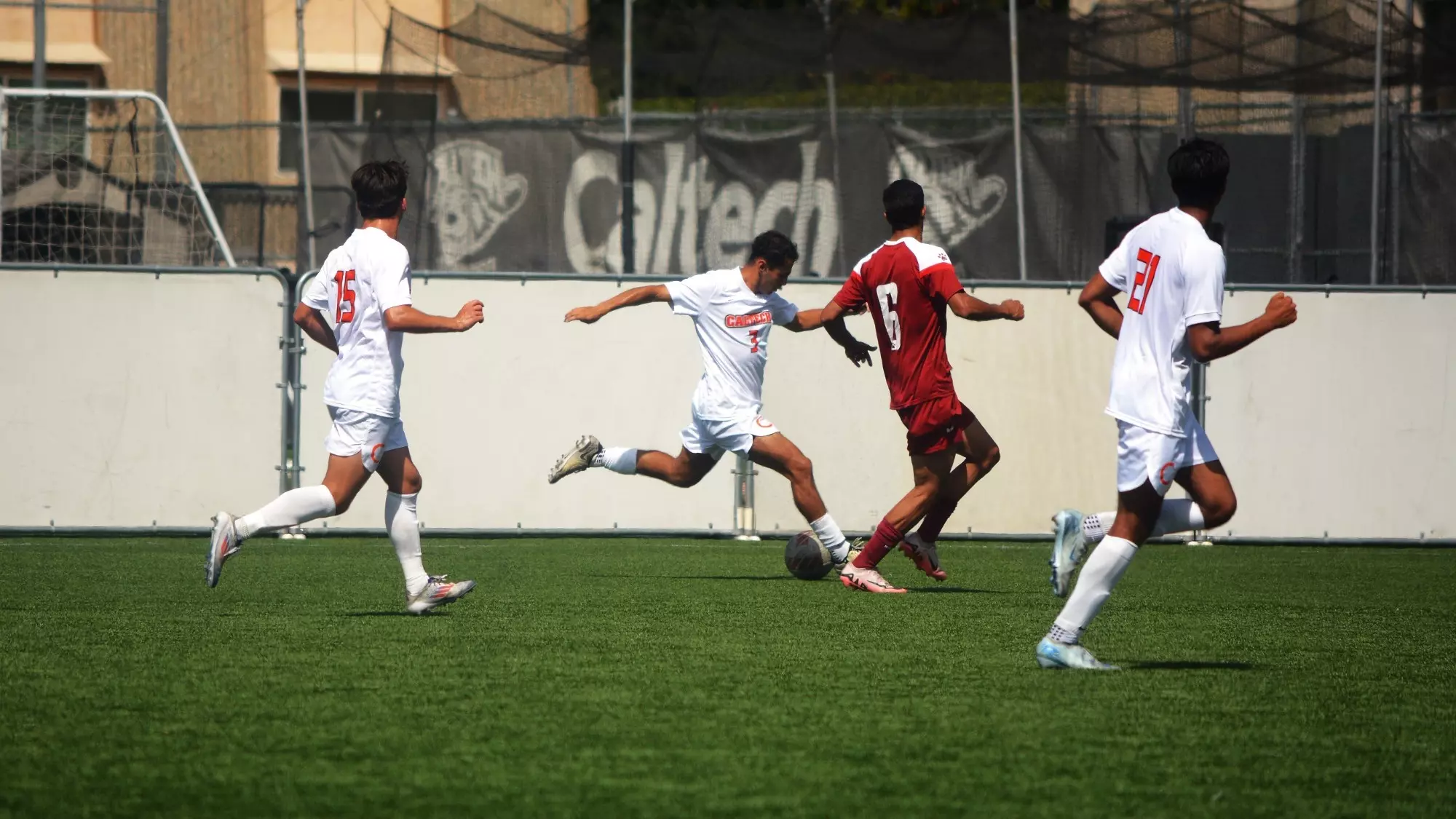 three Caltech players running with the ball with a defender close by