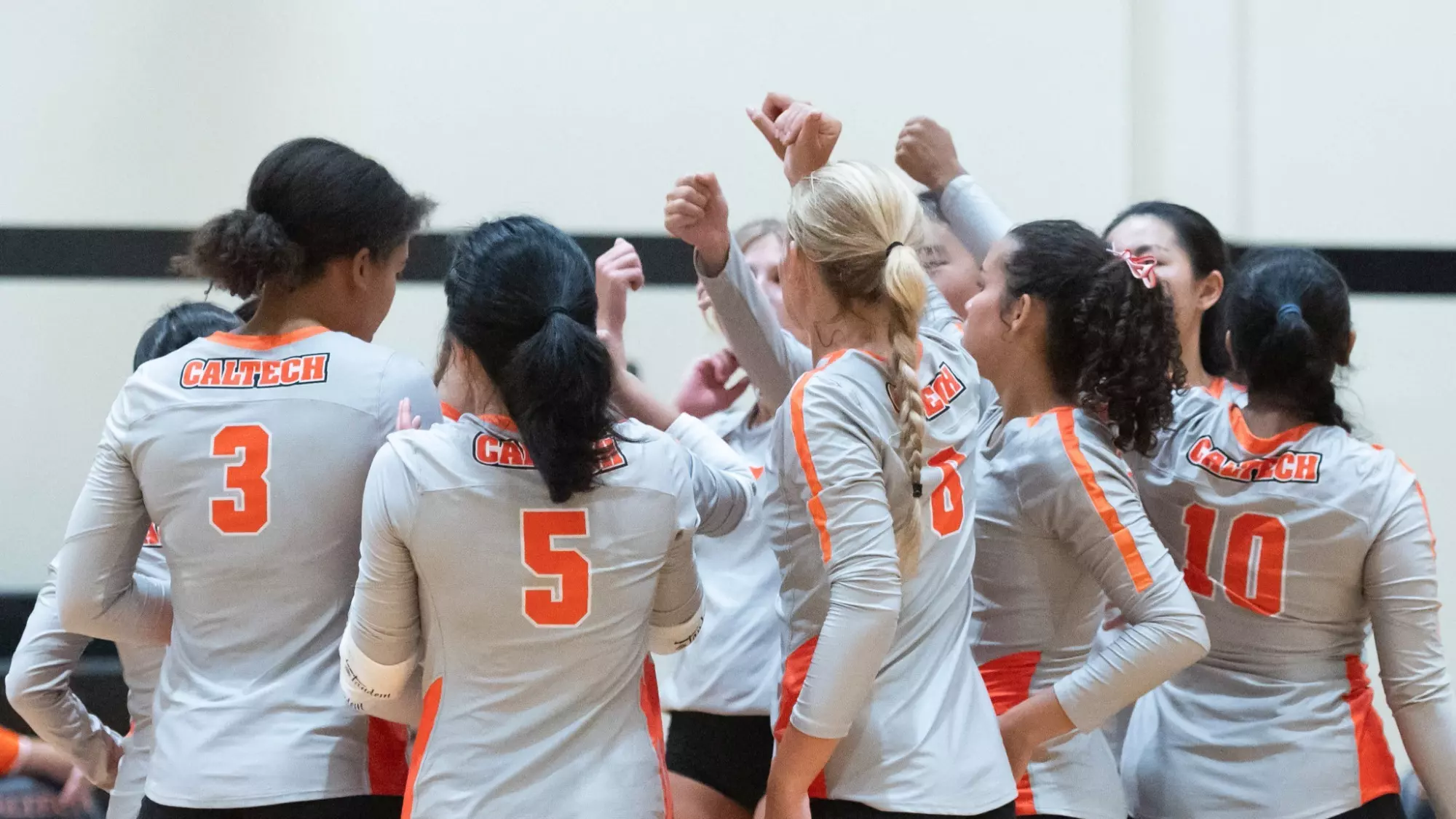 Caltech Volleyball team huddling before a match