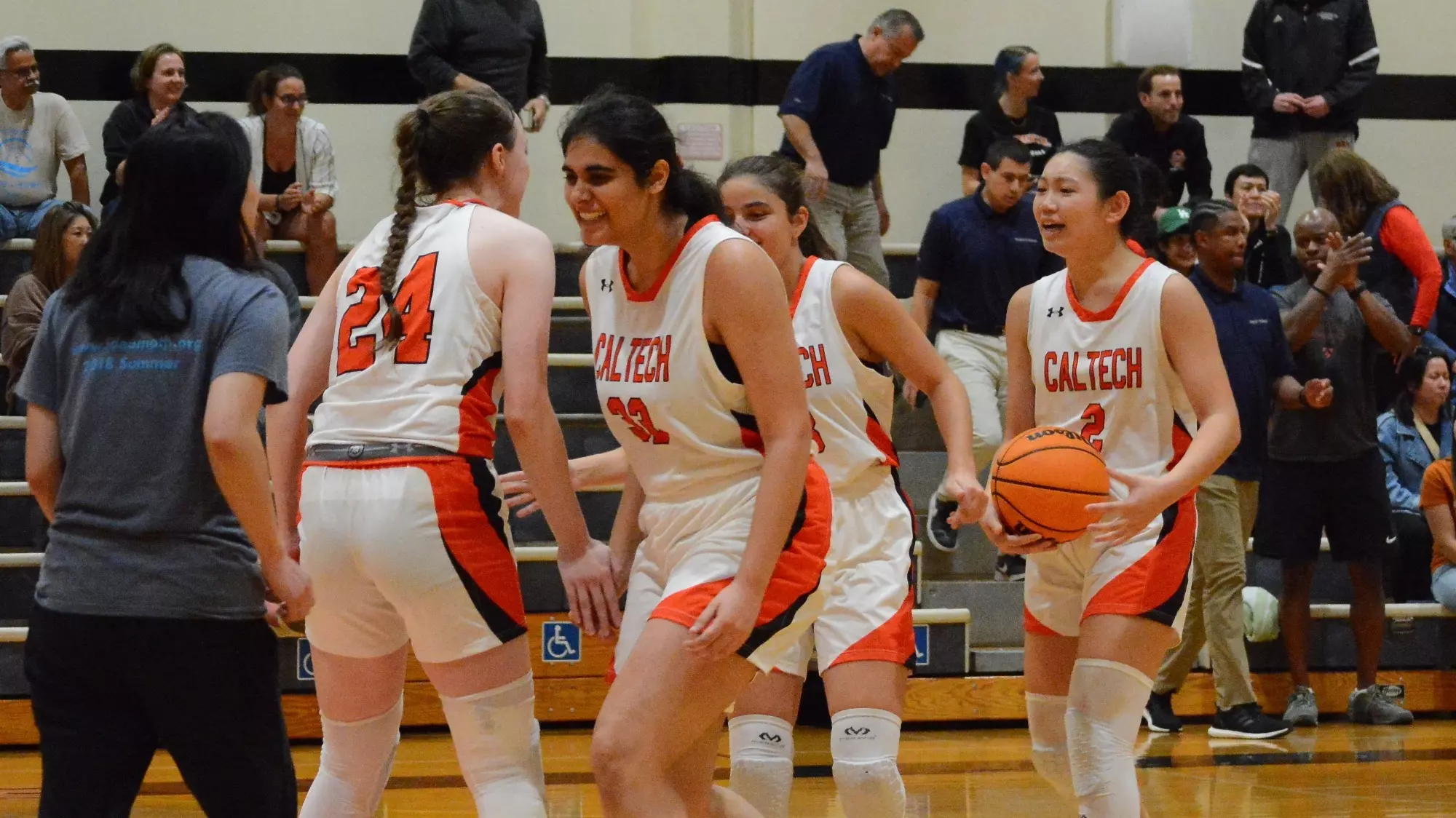 Women's Basketball players celebrating on the court