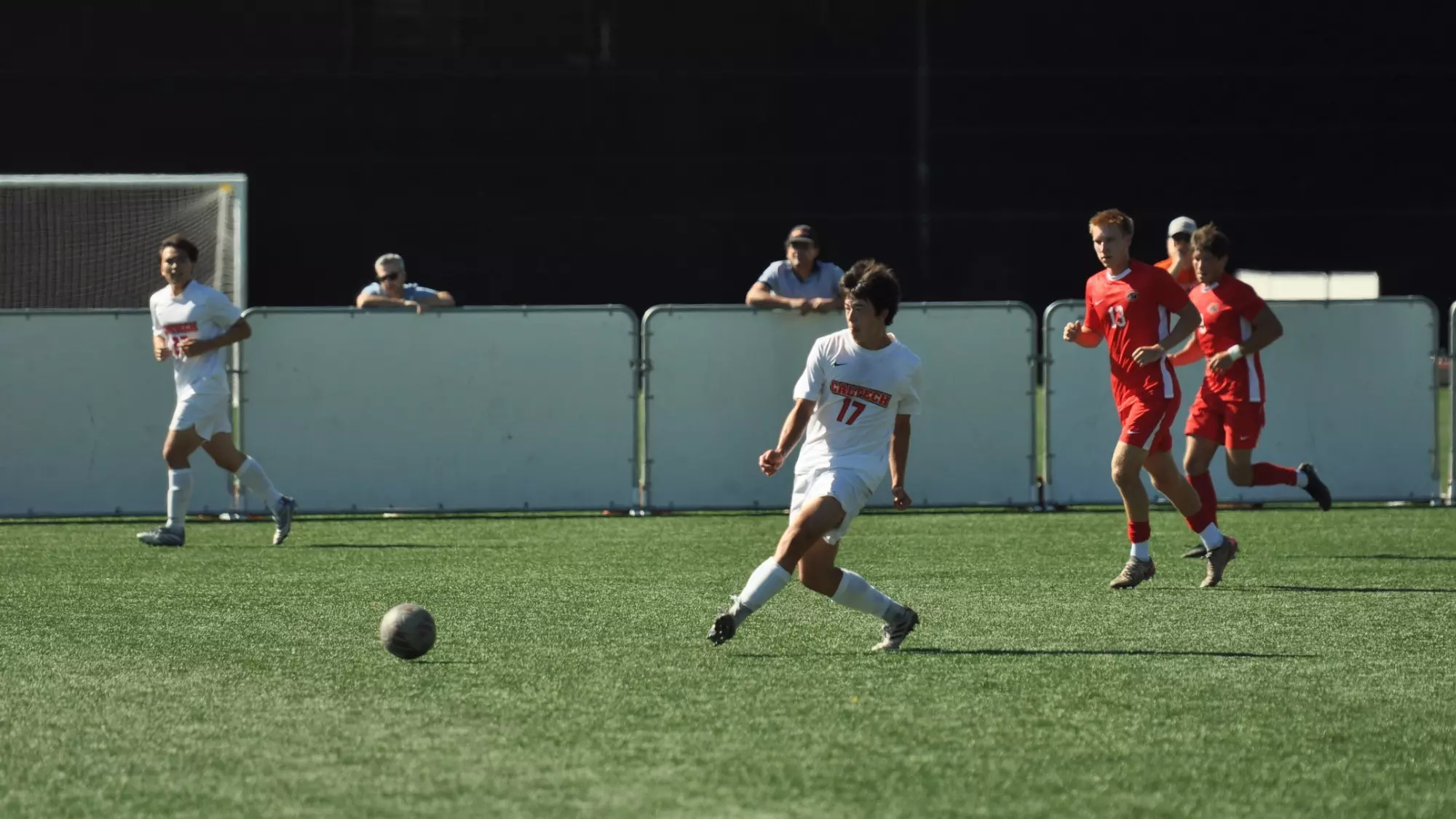 Caltech's Kyler Williams extends his foot after making a forward pass, five yards clear of the nearest Chapman defender. 