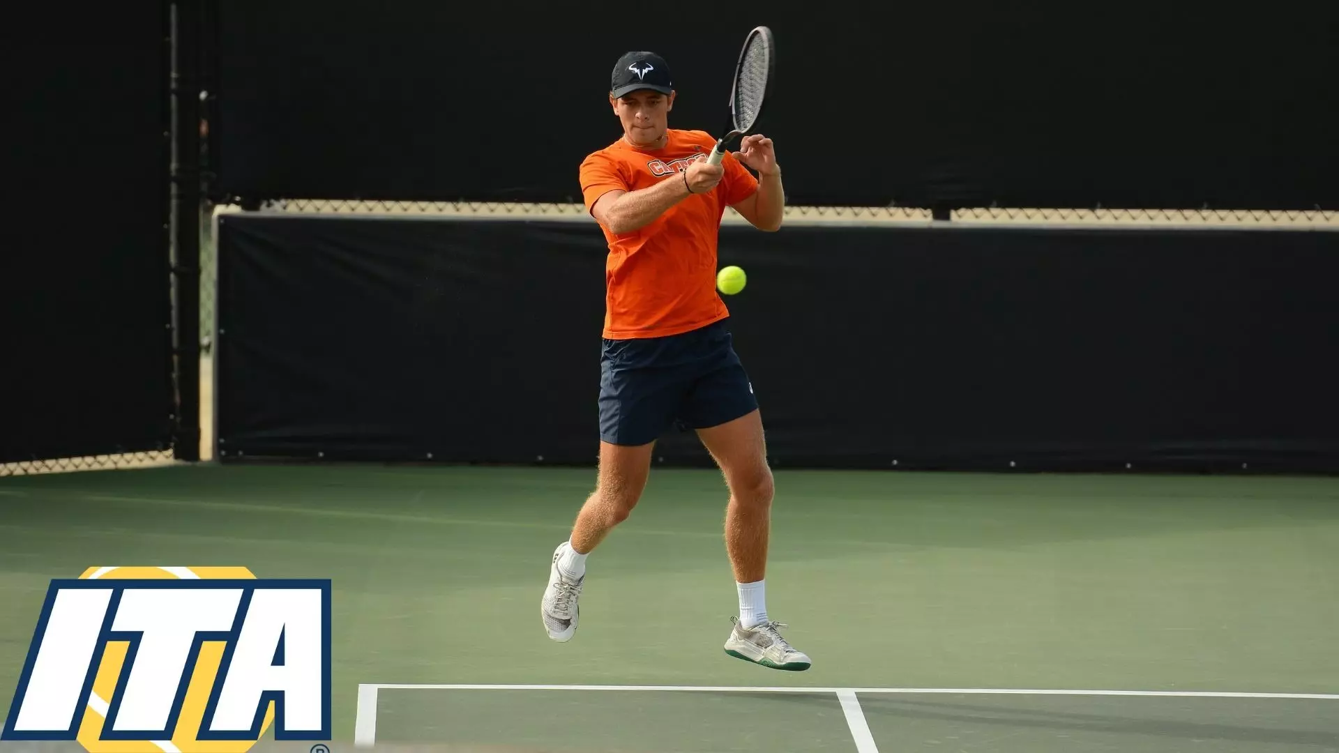 Constantin Cedillo-Vayson de Pradenne elevates off the ground as he hits a shot near the sideline. An ITA logo is placed in the bottom left corner of the image 