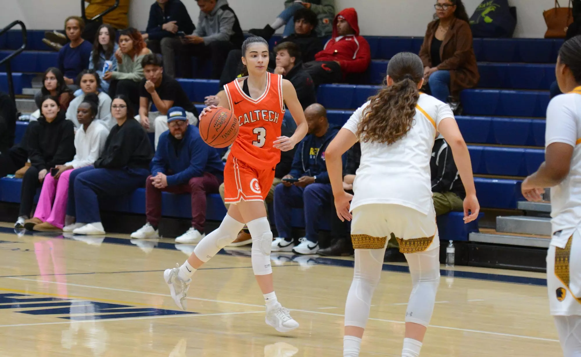 Zeynep Goktepe dribbles toward a pair of Life Pacific defenders