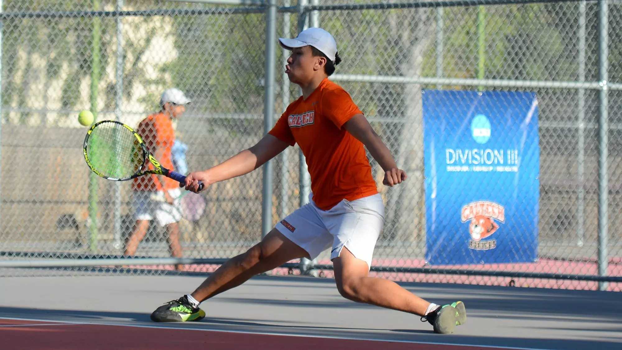 Eric He slides to his right to hit a forehand
