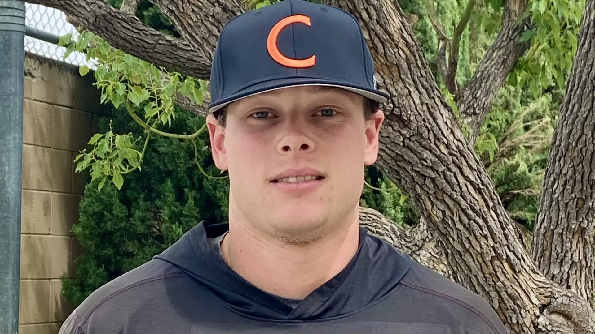 Frank Craska peers into the camera for a standard headshot, wearing a black hat with an orange C on the front. 