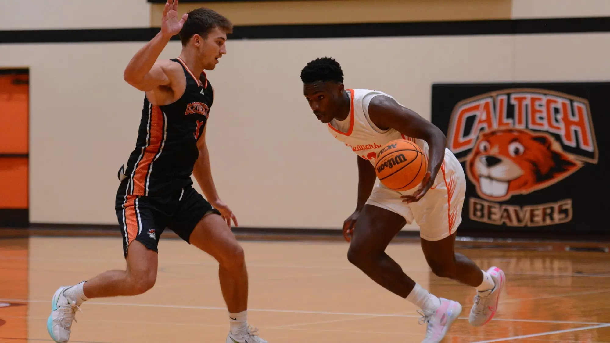 Josh Balami crosses over to his left controlling the ball in his left hand as he moves past a defender against Occidental. 