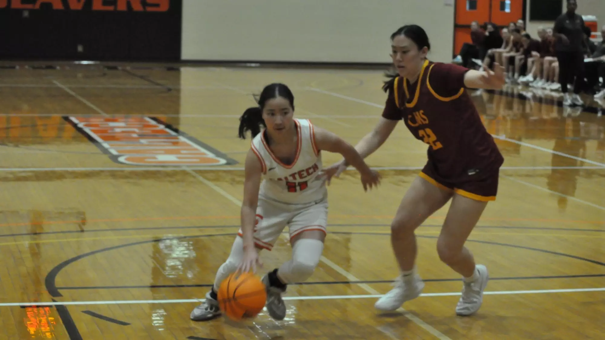 Isabella Lo sustains a low right-handed dribble as she drives the lane against a CMS defender 