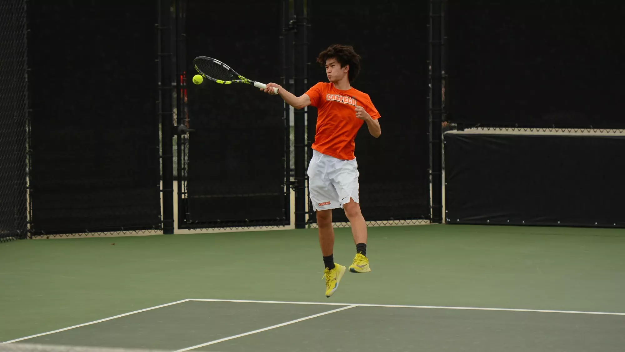 Gao elevates from the ground near the right sideline while attacking a ball with a right-armed swing. 