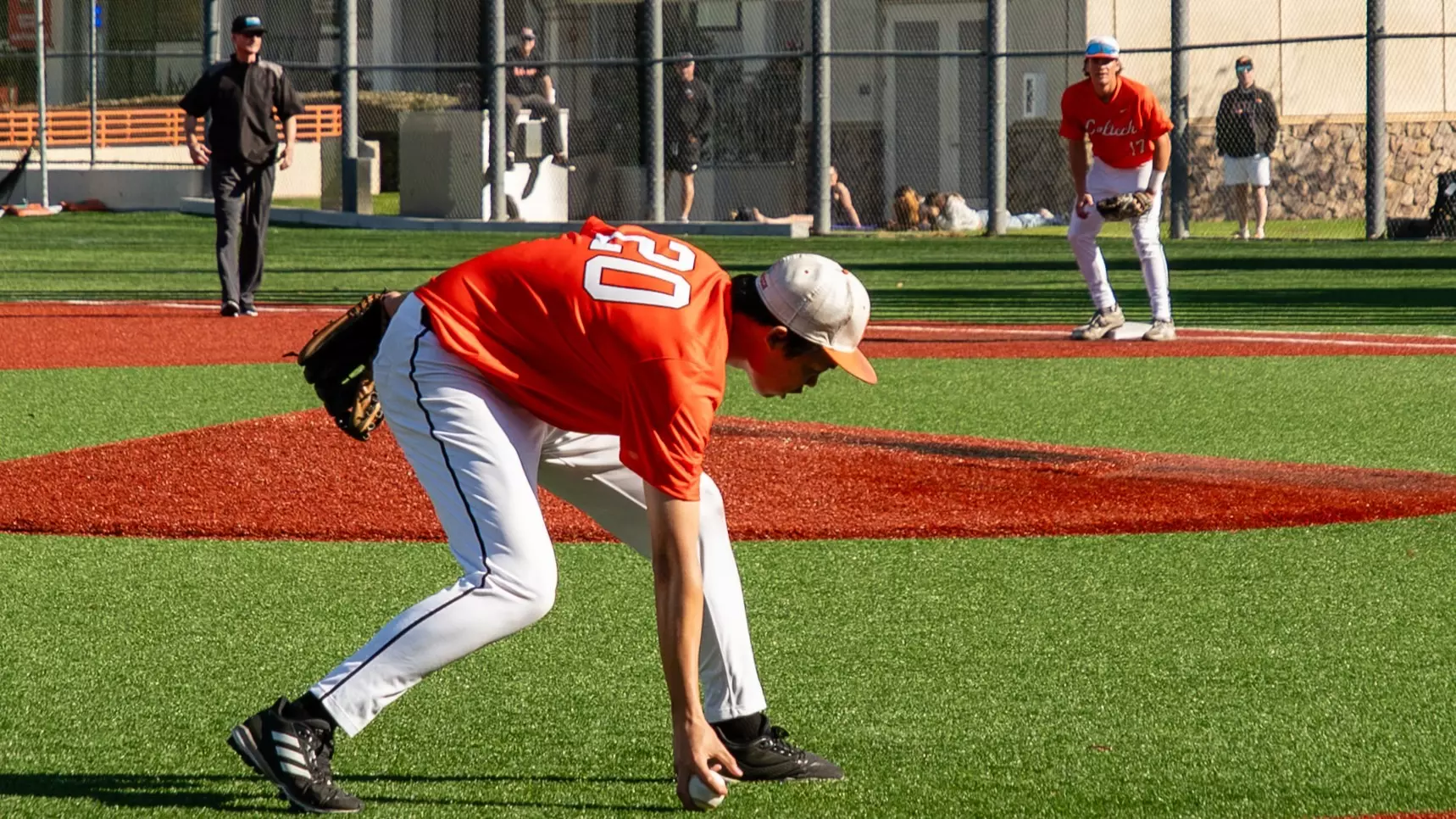 Mark Hu makes a bare-handed fielding play charging in from third base as viewed from the third base dugout. 