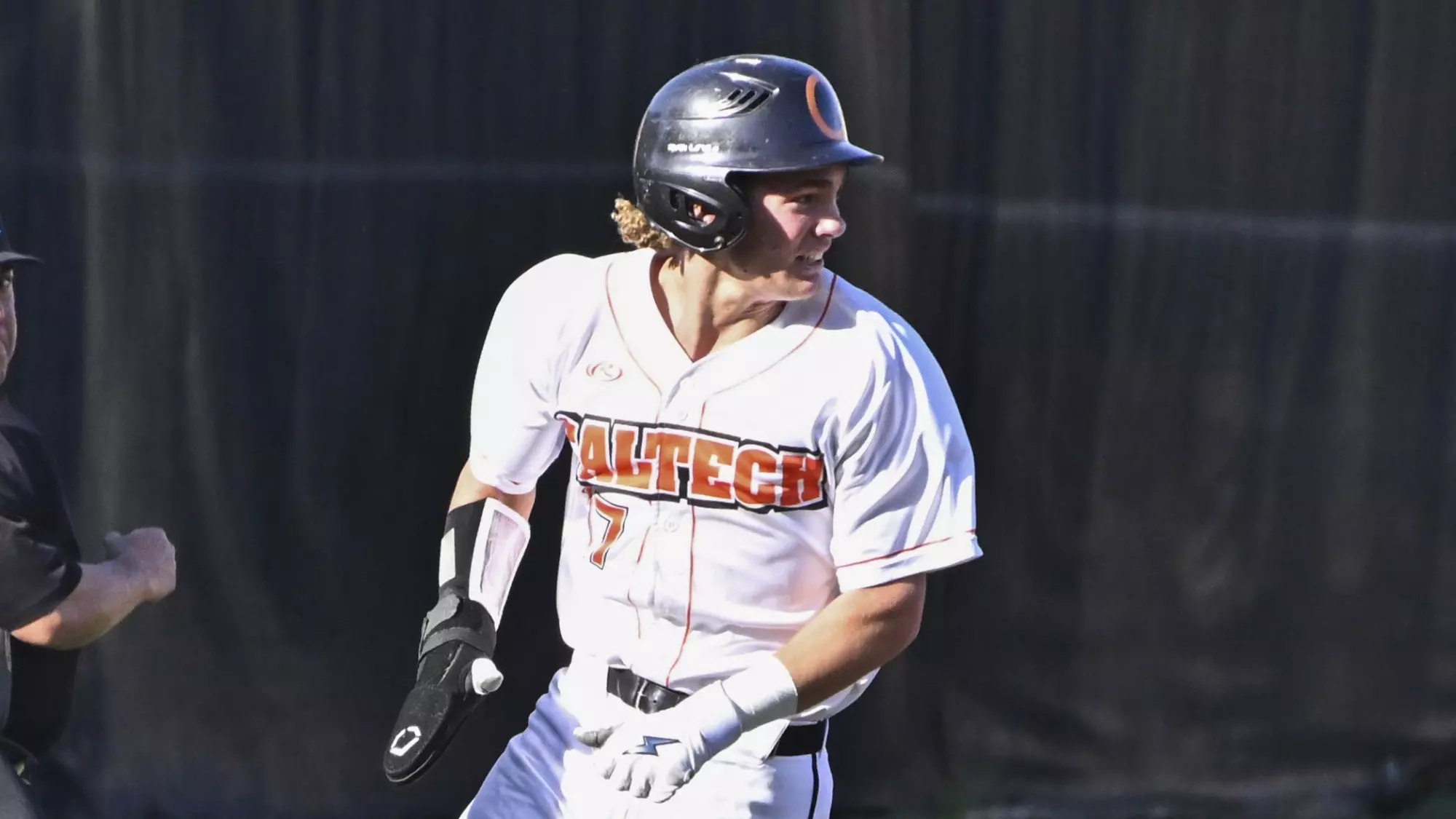 Quinn Hartman rounds third base as he looks over his left shoulder