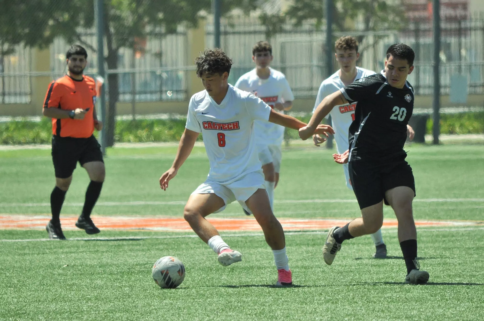 Dean Yao controls the ball next to an opposing player