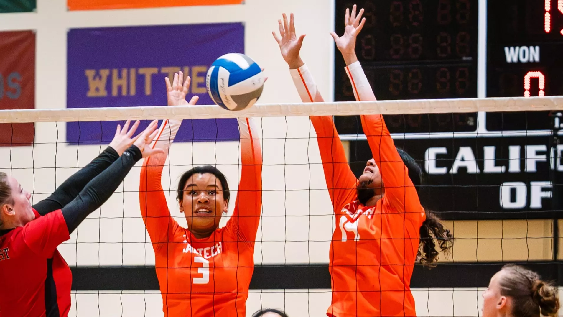 Stephanie Wallen and Veda Chennupati rise to attempt a block against West Coast Baptist University 