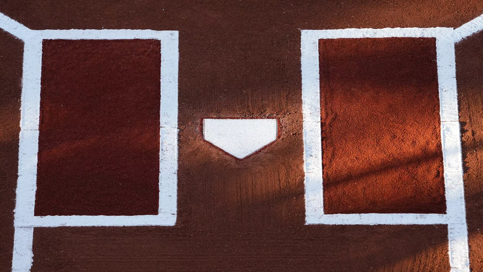 This is a picture of home plate at an NCAA women's softball game.