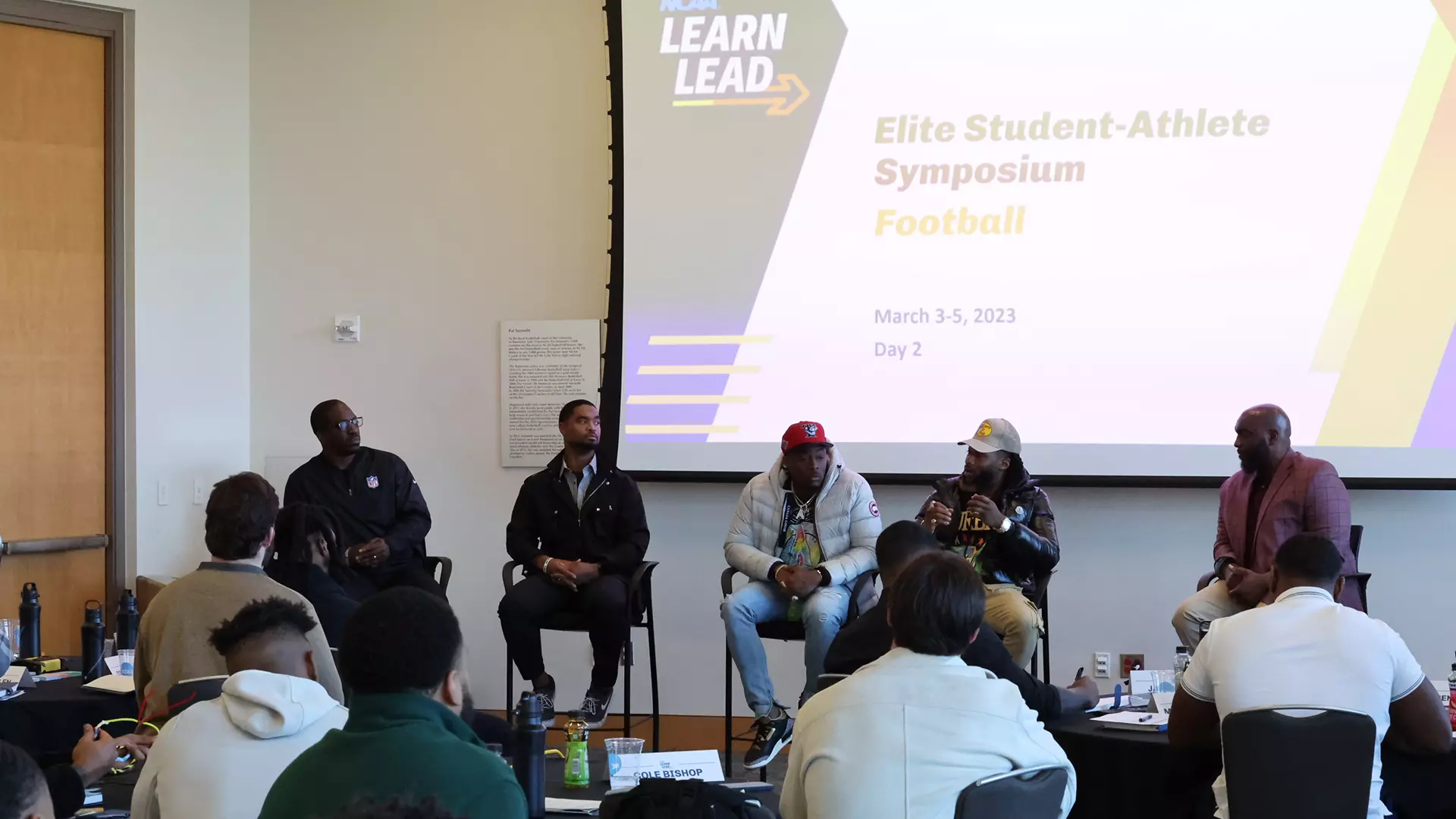 A panel of current and former NFL players speaks to attendees of the 2023 Elite Student-Athlete Symposium for Football 