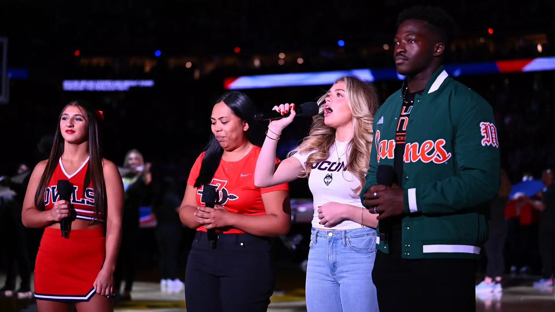 A representative from each of the schools in the Men’s Final Four sings the national anthem before Saturday’s semifinal games