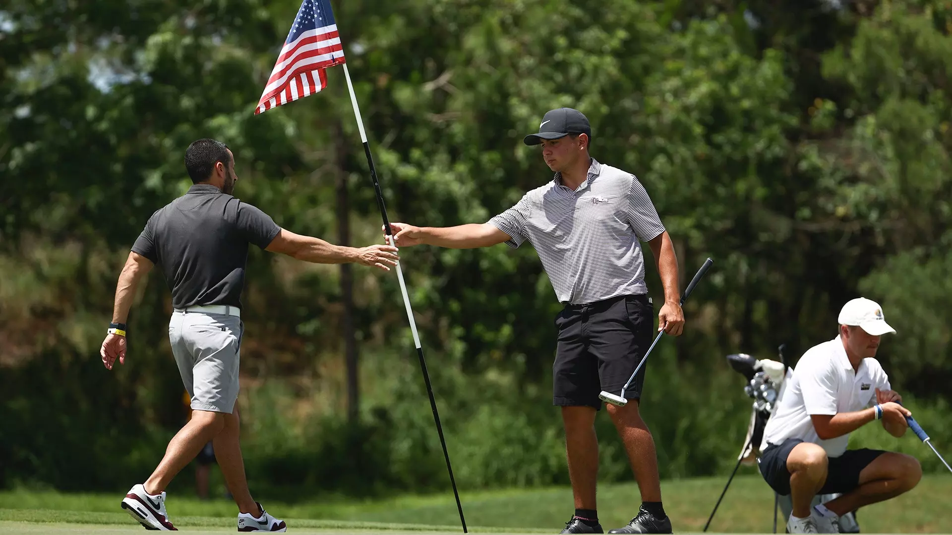 The pin flags on the first, 10th and 18th holes were American flags as part of the day honoring fallen soldiers. (Photo by Tyler Schank / NCAA Photos)