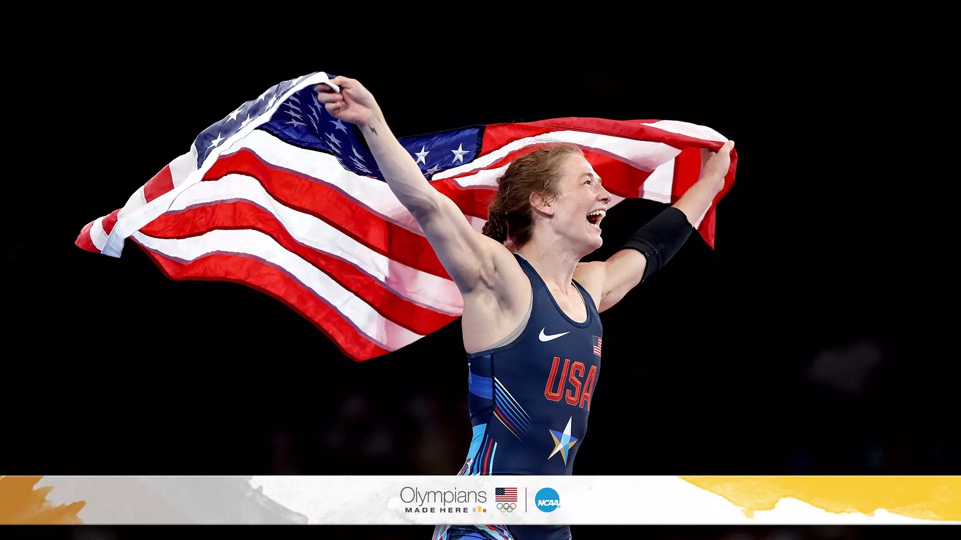 Sarah Hildebrandt begins her victory lap after clinching the gold medal in the 50-kilogram weight class at the Olympics, proudly draping the American flag over her shoulders. 
