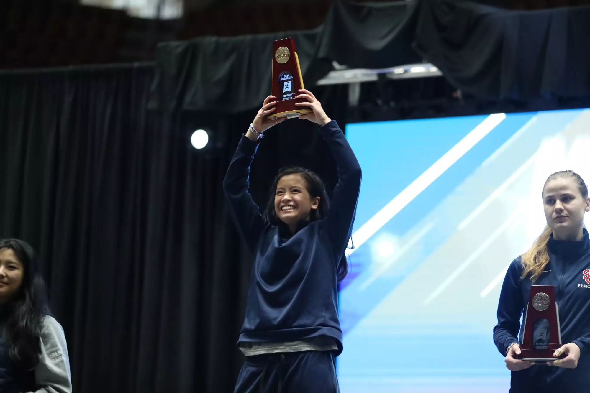 Maggie Shealy holds her 2024 NCAA Championship trophy above her head