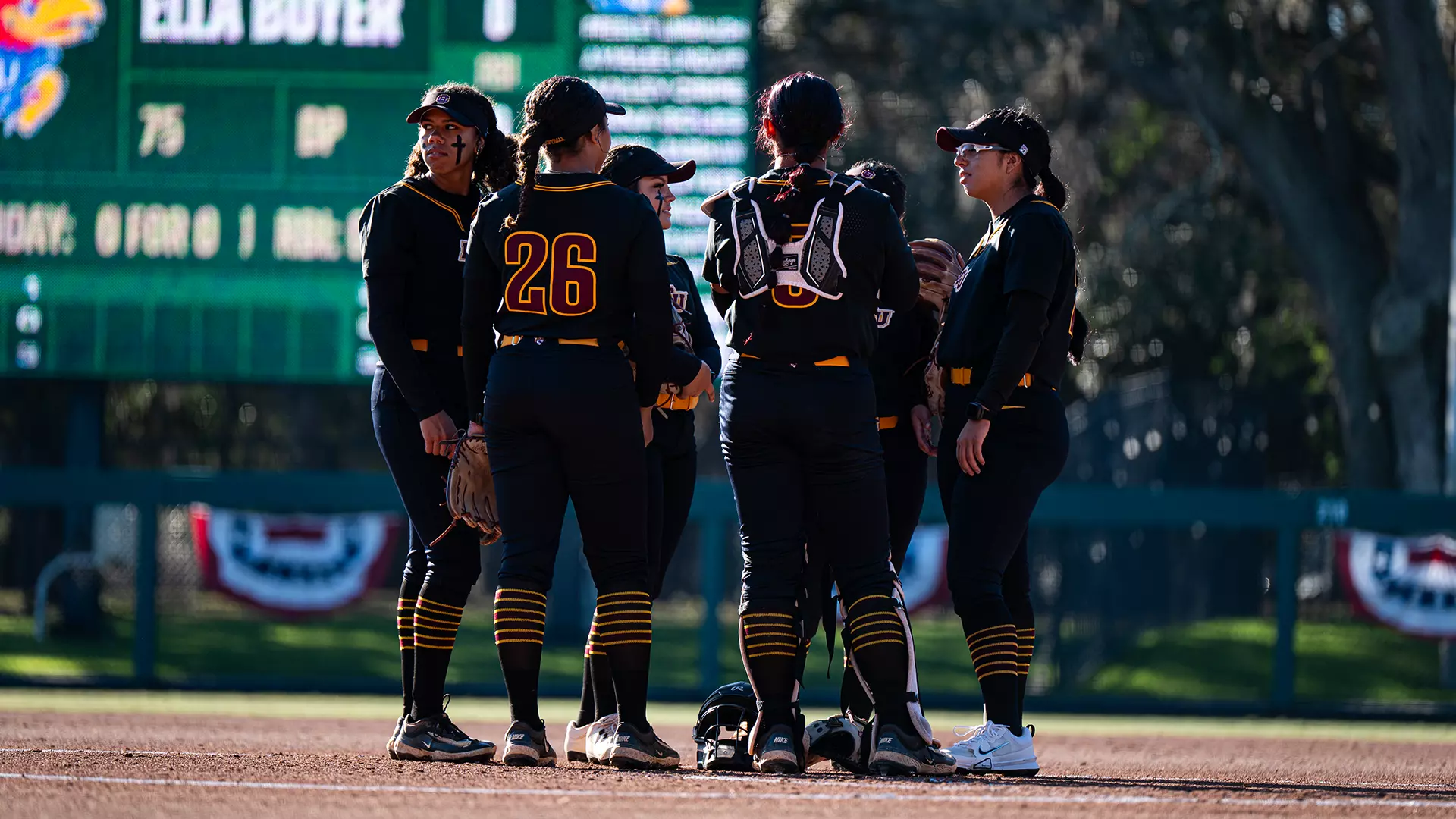 Softball team huddle vs. Kansas (USF)