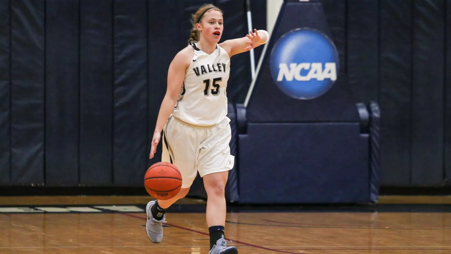 becky evans calls out a play as she dribbles the ball in the backcourt