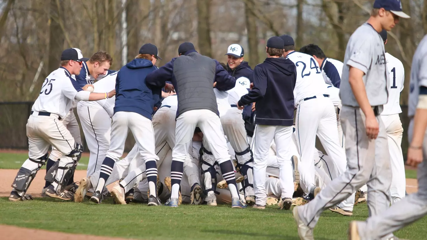baseball dog piles at first base after walkoff win over messiah