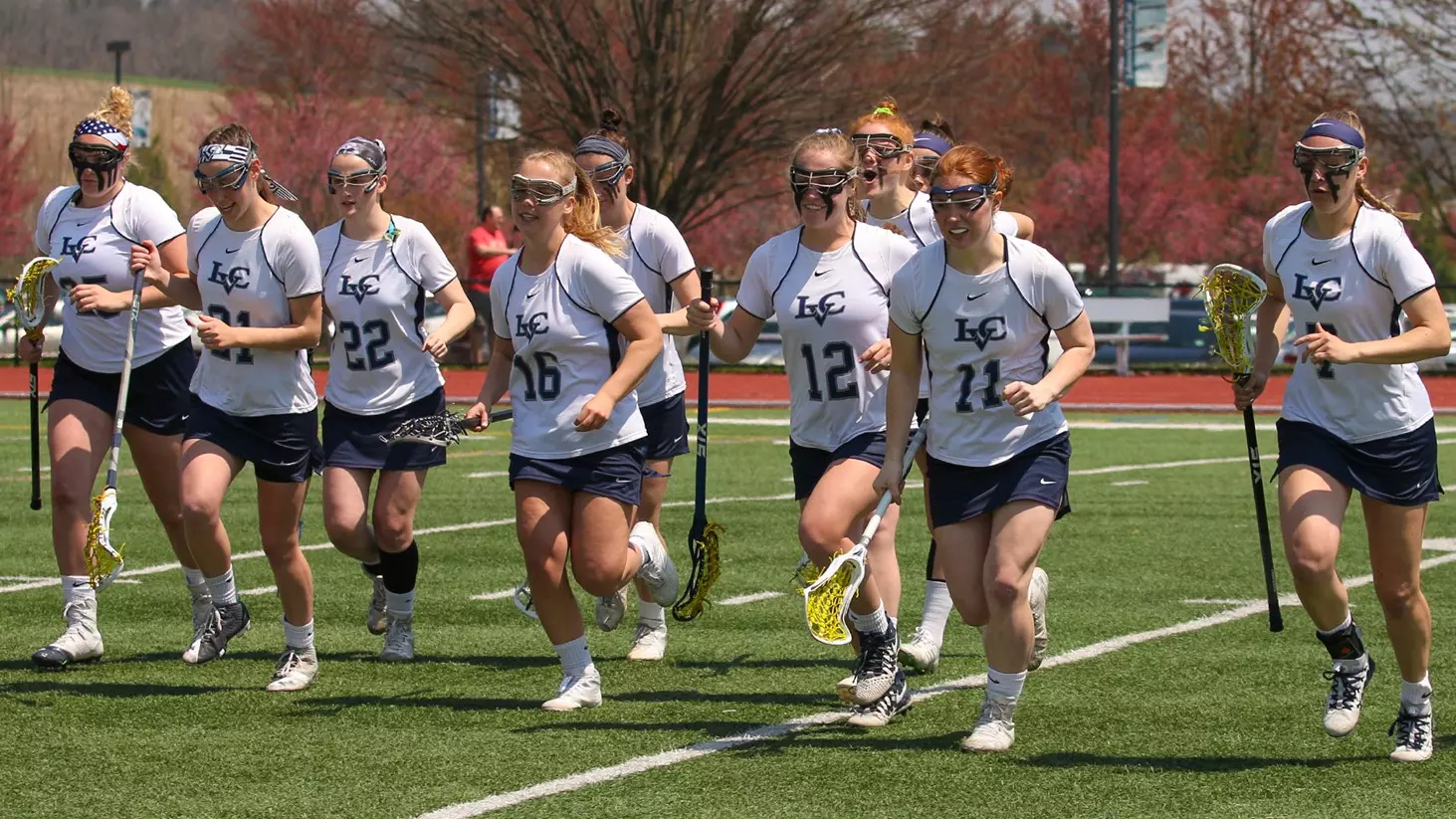 women's lacrosse runs toward the sideline after pregame introductions