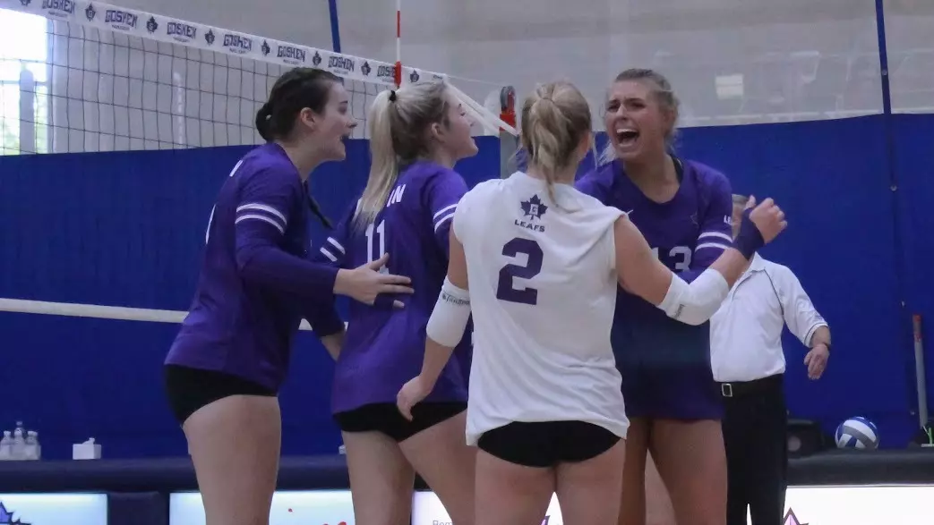 Women's volleyball team celebrates a point