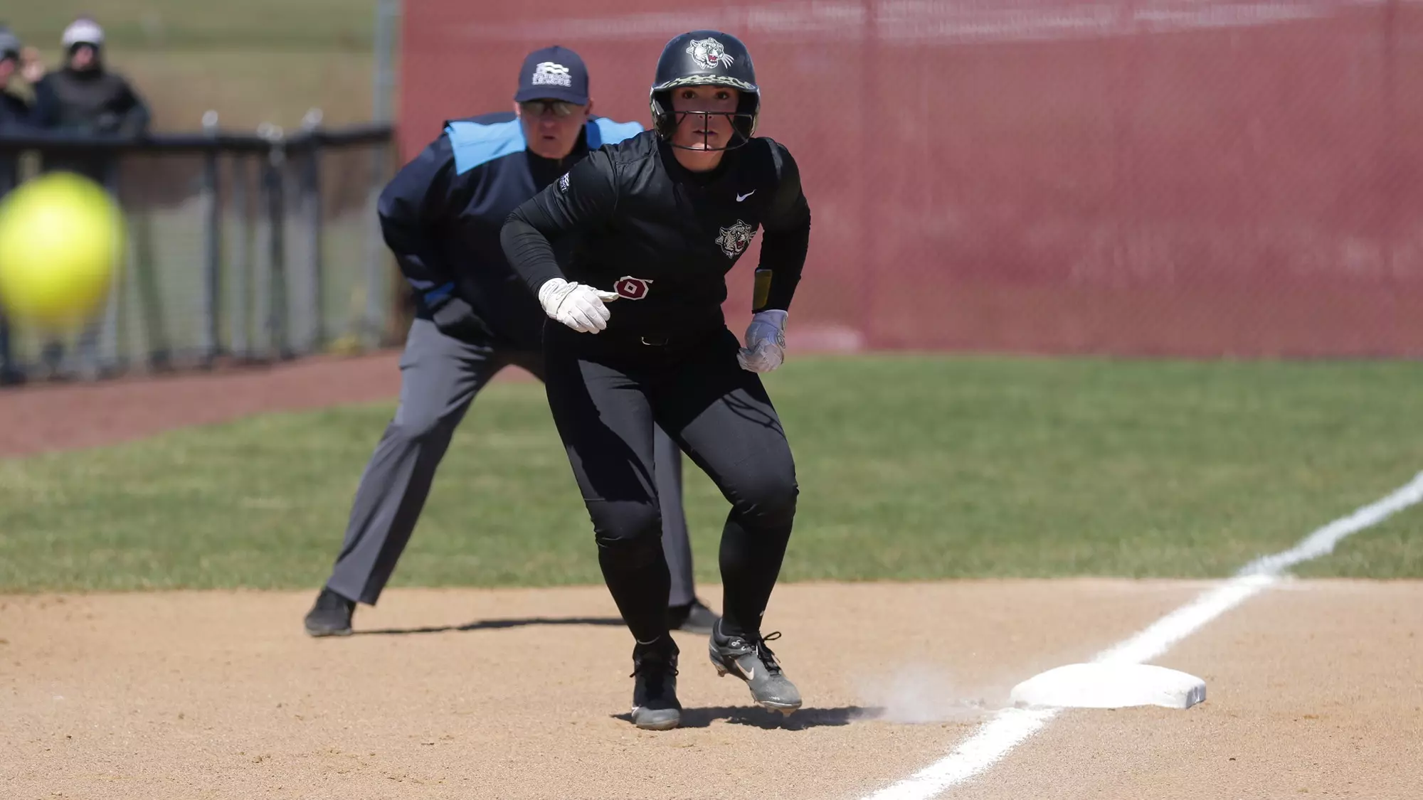 Megan Coyle steps off third base