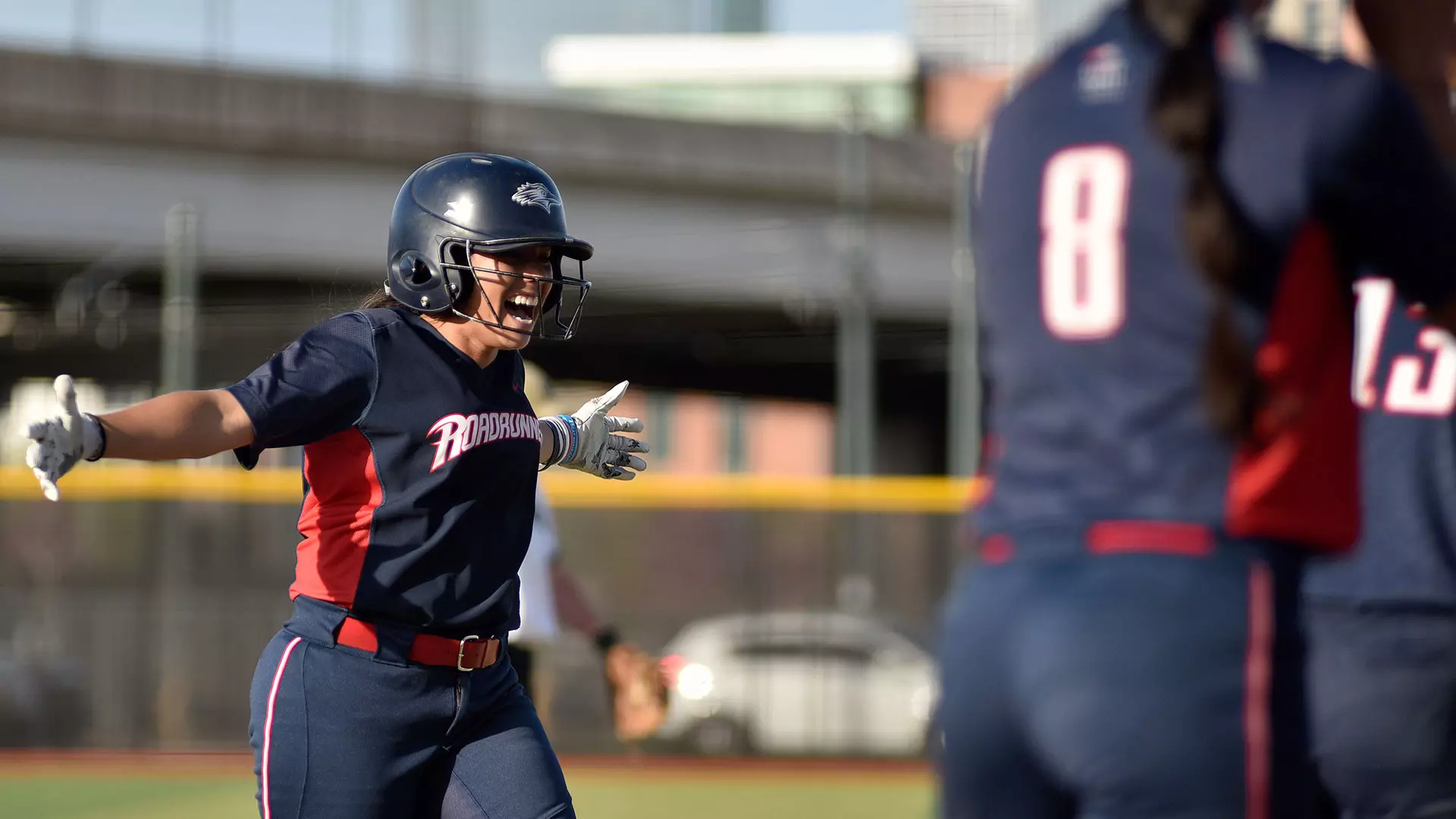 Excited MSU Denver player facing two team mates