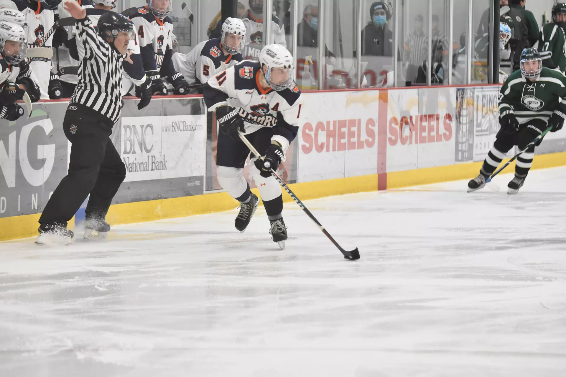 Alex Flicek flies down the ice in front of the Marauders bench
