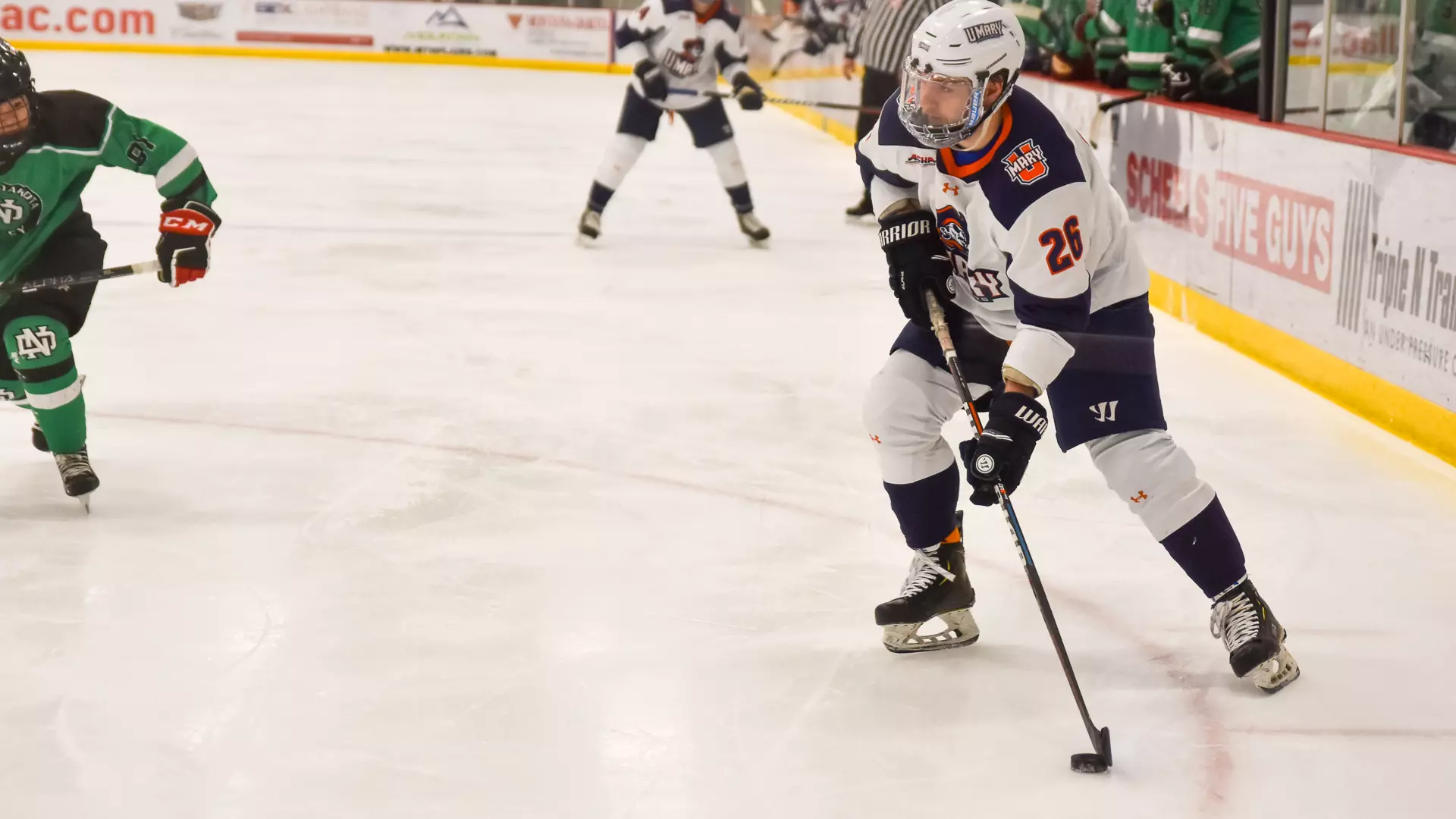 Kyler Moore looks to move the puck against UND