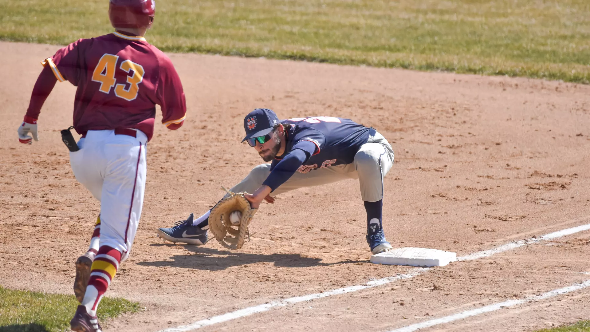 Derek Shoen makes the putout at first base