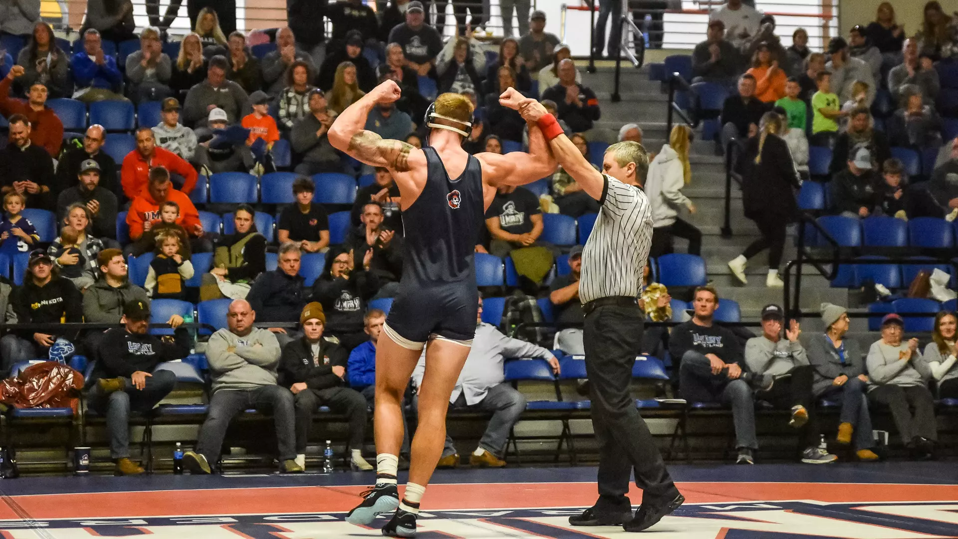 Official raises Matthew Kaylor's hand after a win over Minot State