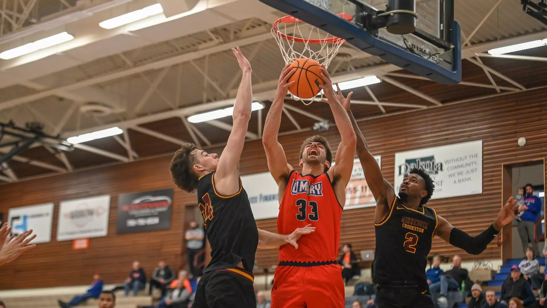 Lucas Mayer attacks the basketball between two defenders