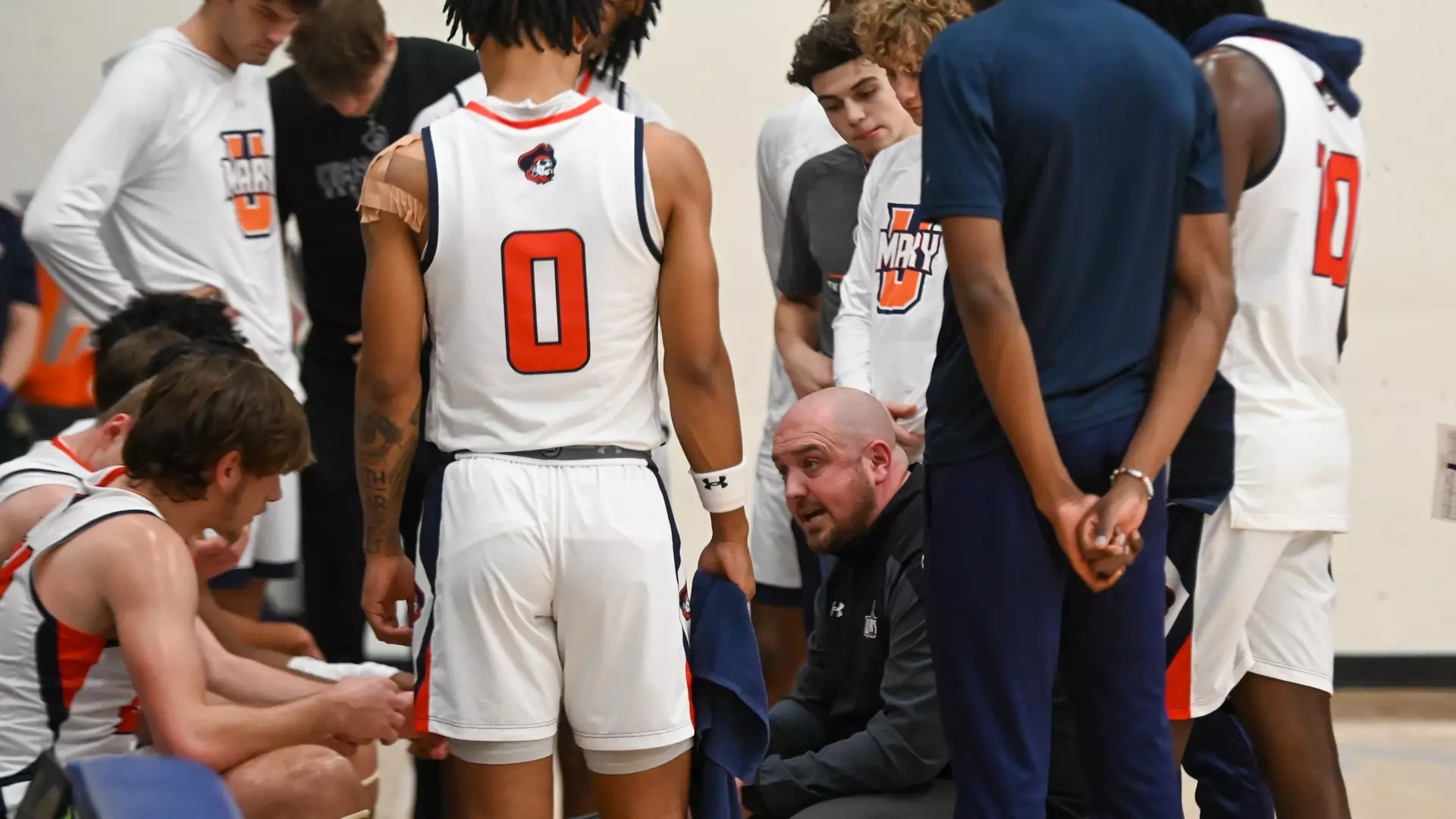 Head coach Jack Nelson talks to his team