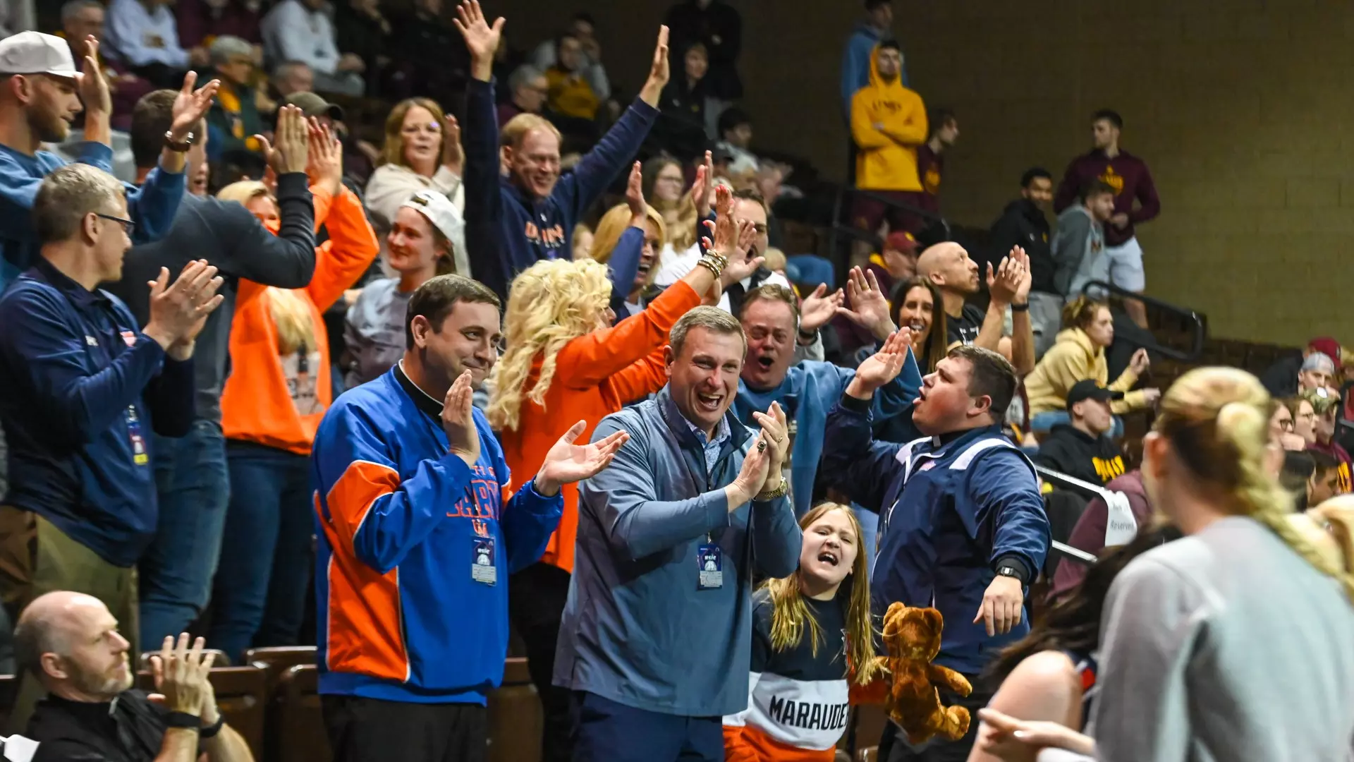 Monsignor Shea and AD Cooper Jones cheering on the Marauders