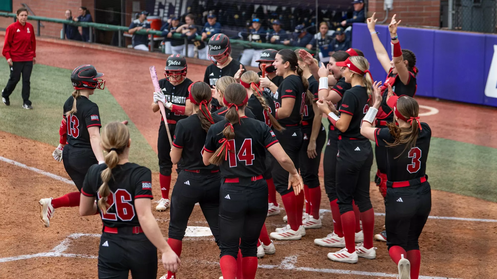 Madison Evans celebrating with team after home run