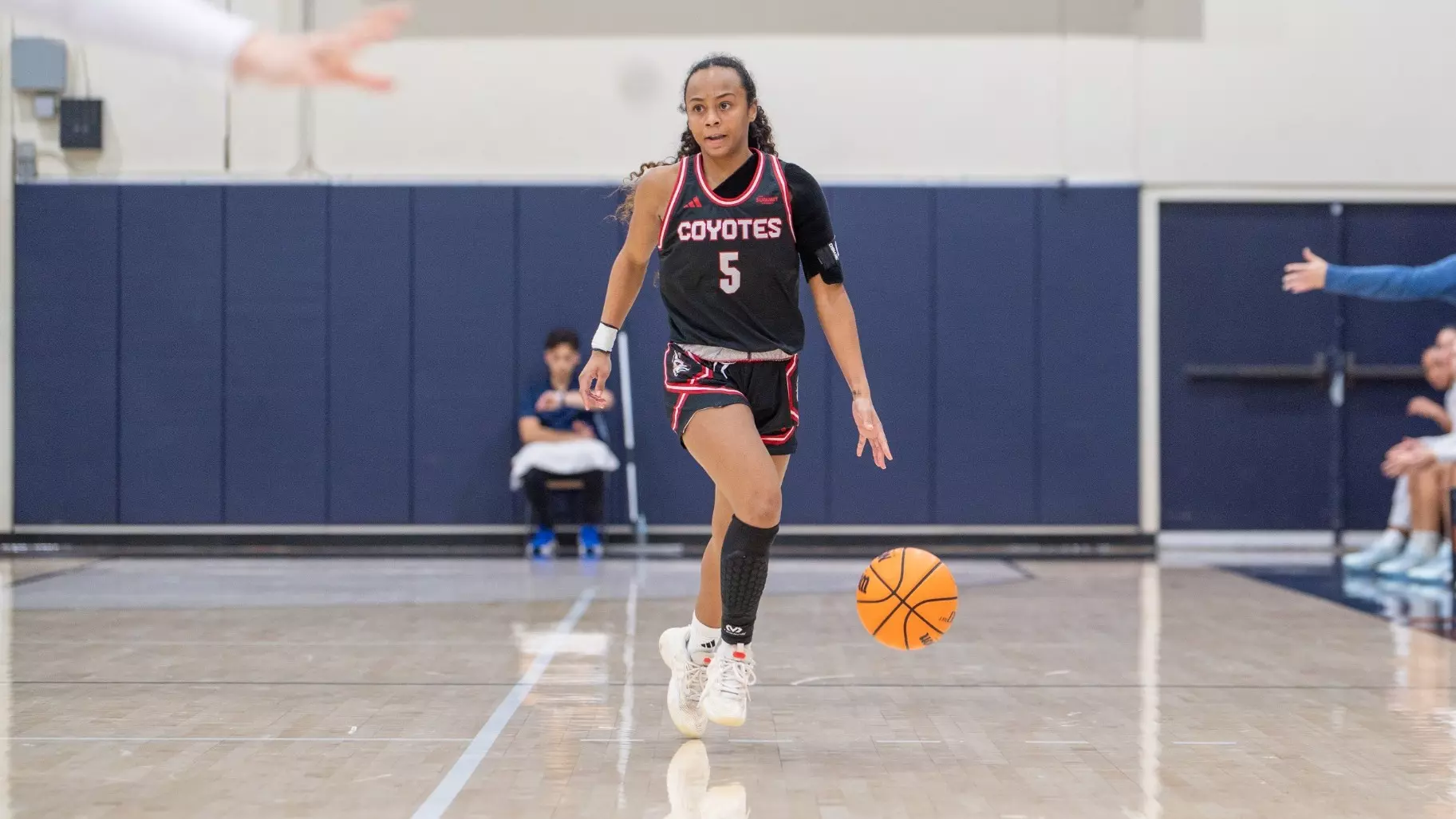 Angelina Robles dribbles the basketball during a game